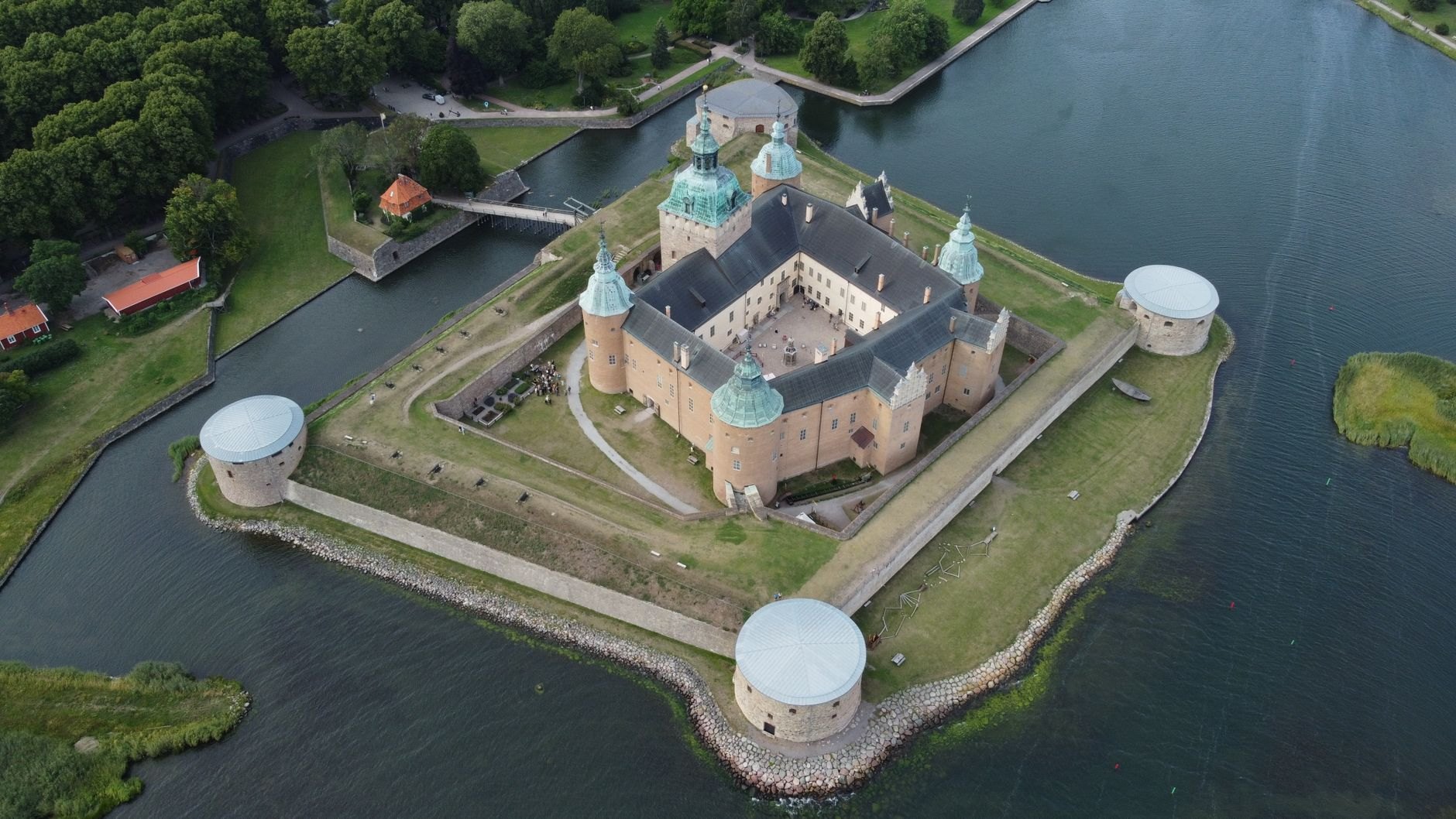 Fourteenth-century square stone bishop castle surrounded by defensive moats and green earthen bastions on Saaremaa