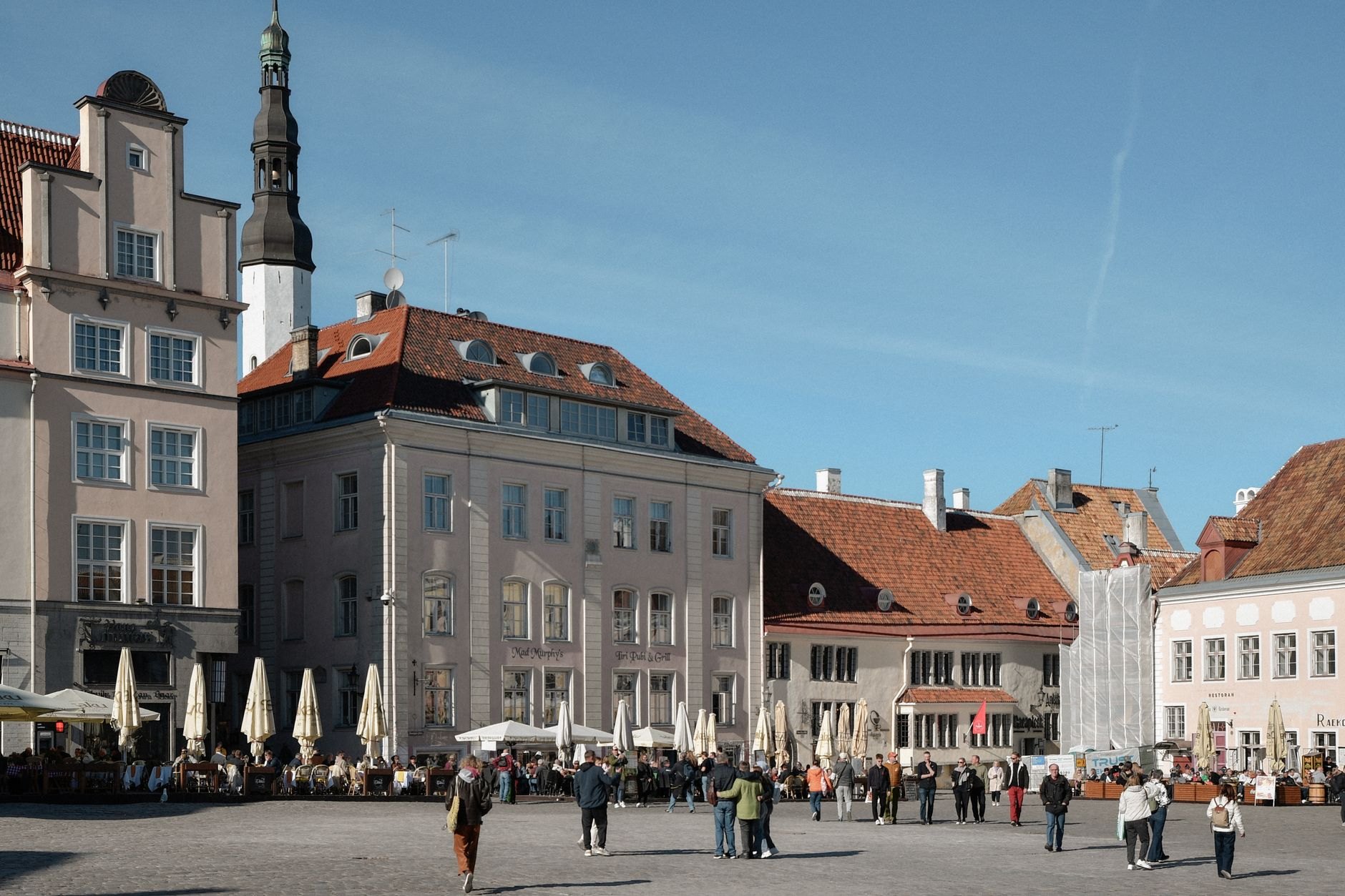 Gothic Tallinn Town Hall with its slender octagonal tower presiding over the cobblestone Raekoja plats