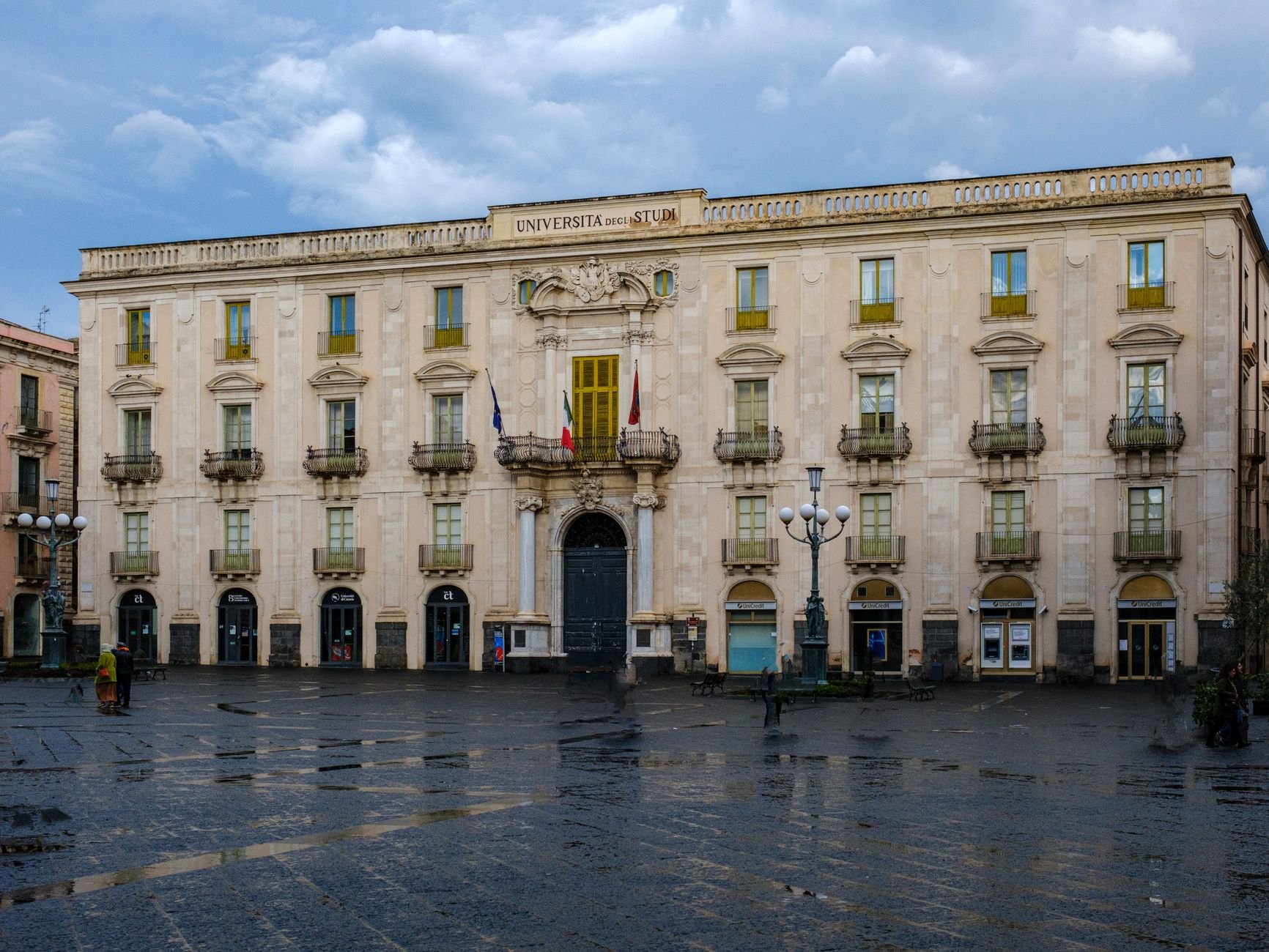 Neoclassical columns of the University of Tartu main building facing quiet historic cobbled streets