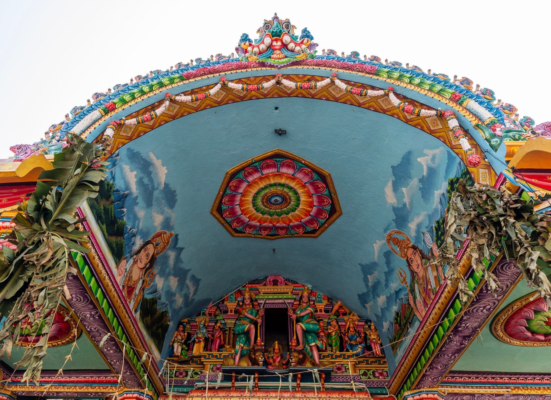 Ornately sculpted and painted multi-tiered Dravidian gopuram tower of Sri Siva Subramaniya Hindu temple in Nadi under tropical sunshine