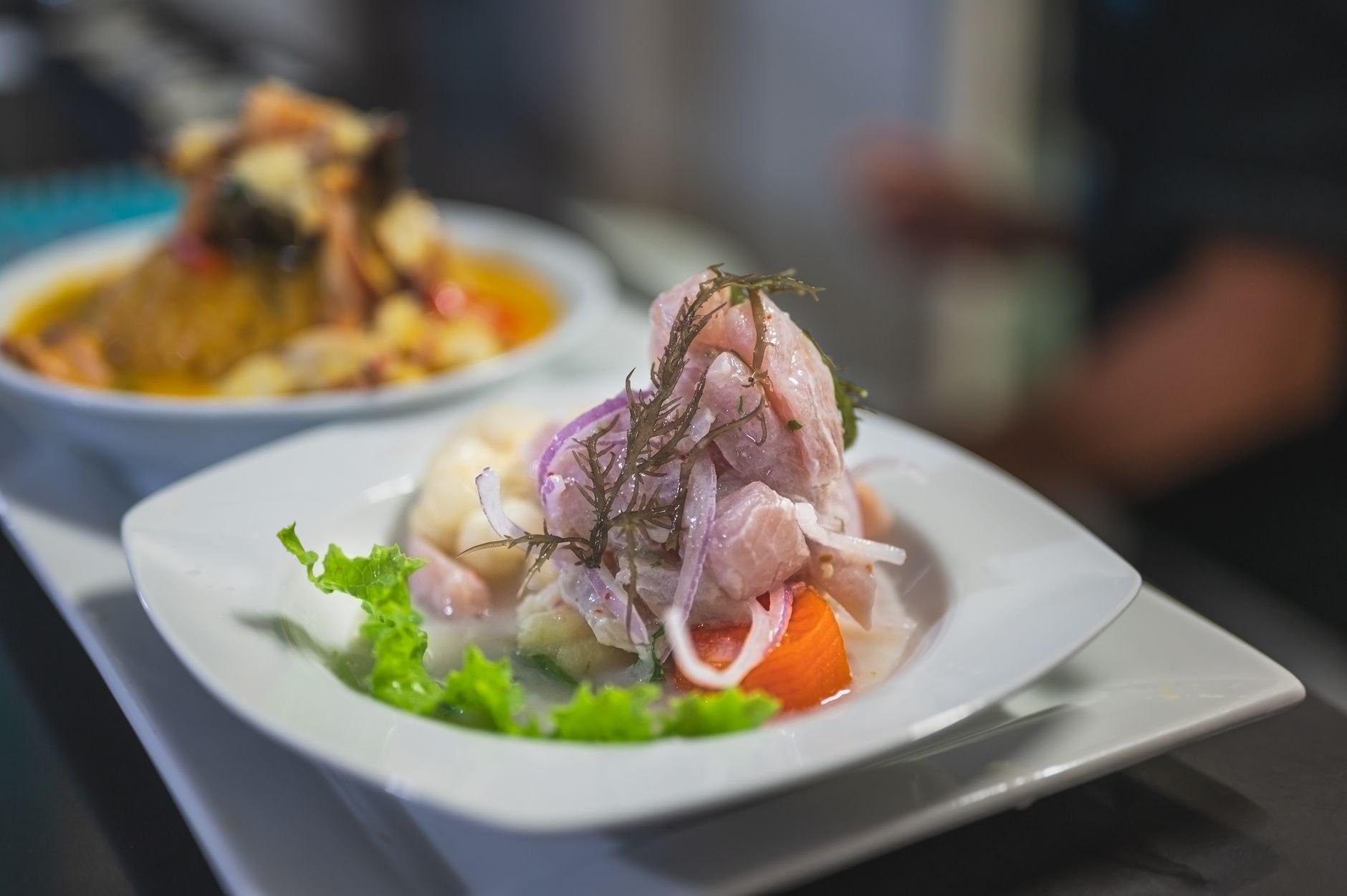 Freshly marinated raw fish ceviche tossed with fresh coconut cream, lime juice, red chili, and diced spring onions served in a half coconut shell