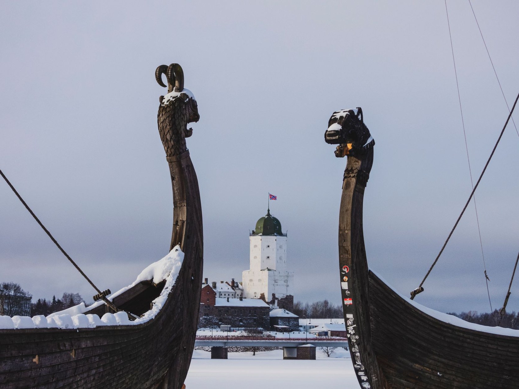 Round granite defense towers and stone ramparts of medieval Olavinlinna Castle surrounded by the waters of Lake Saimaa