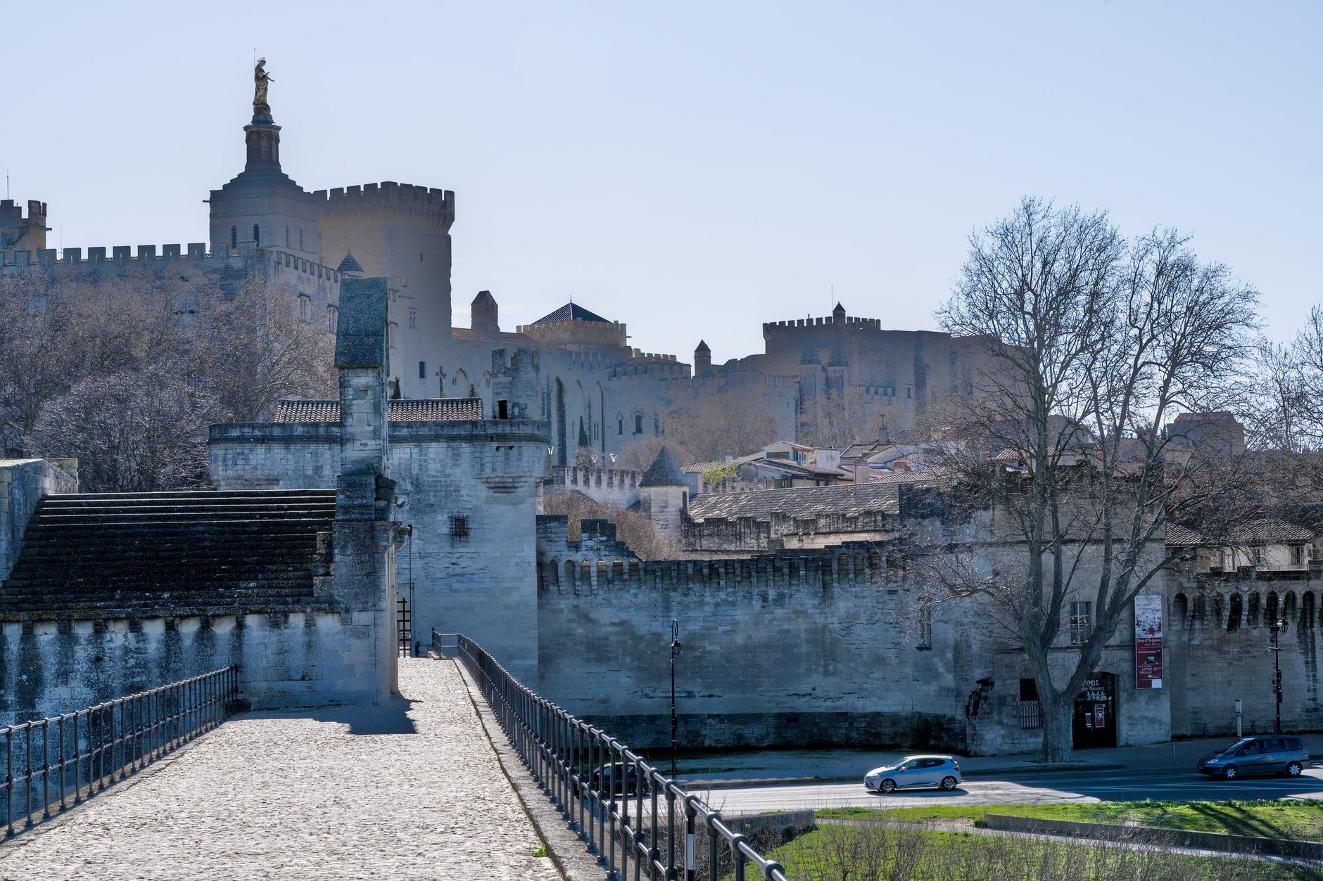Monumental stone fortress walls of the Palais des Papes in Avignon