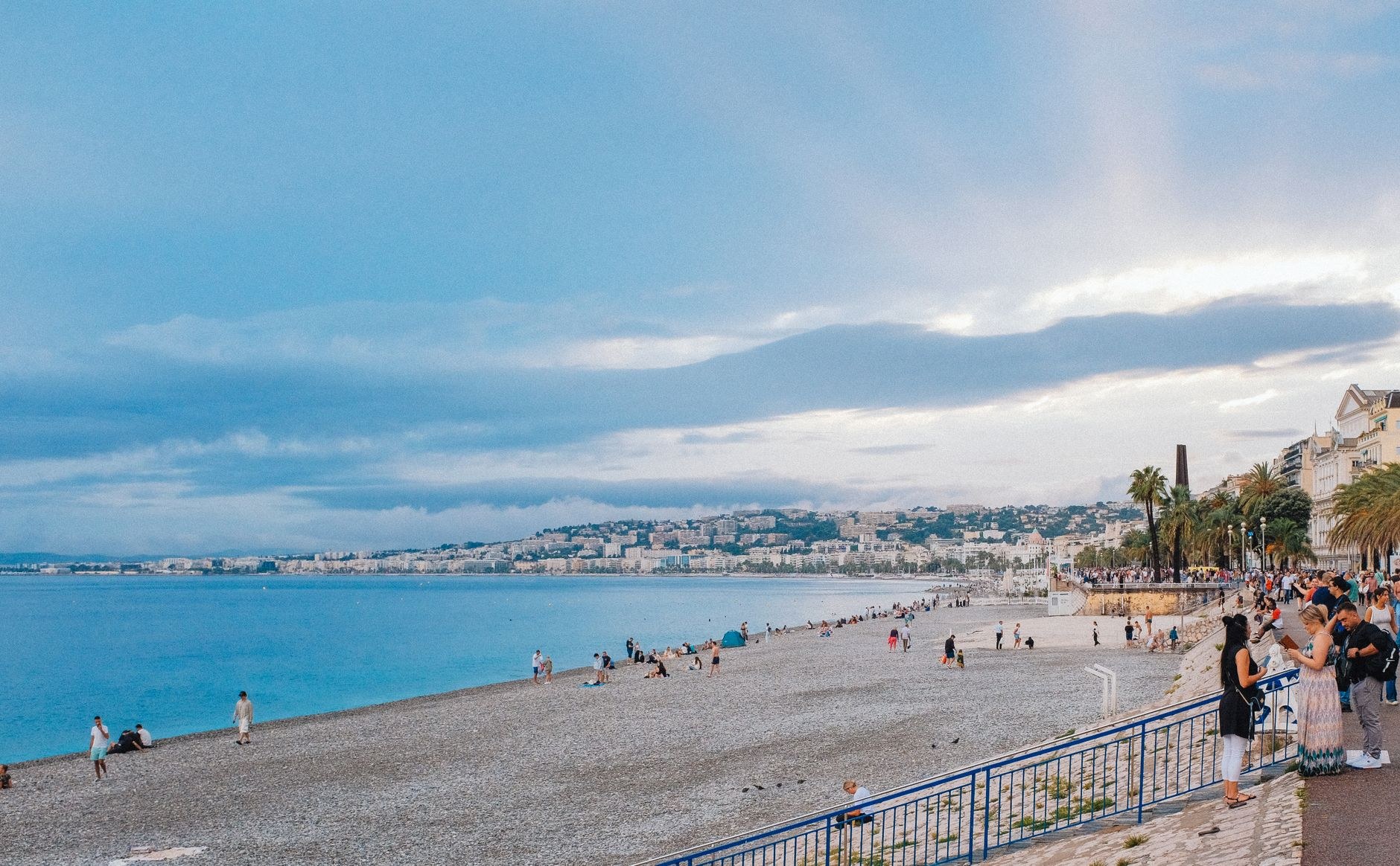 Curving palm-fringed Promenade des Anglais overlooking turquoise waters in Nice