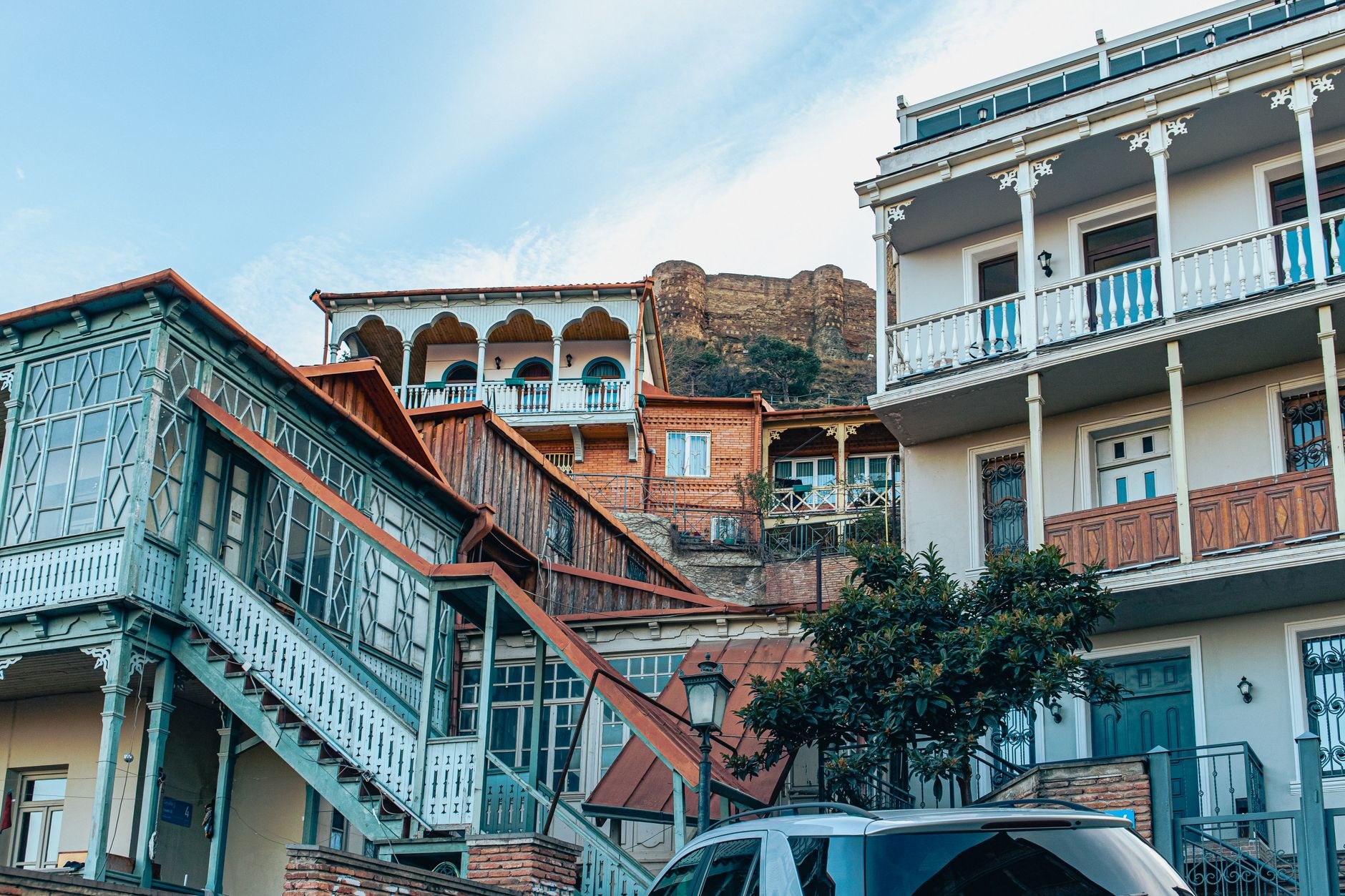 Intricately carved pastel wooden balconies and winding cobbled alleys in Old Tbilisi, Georgia