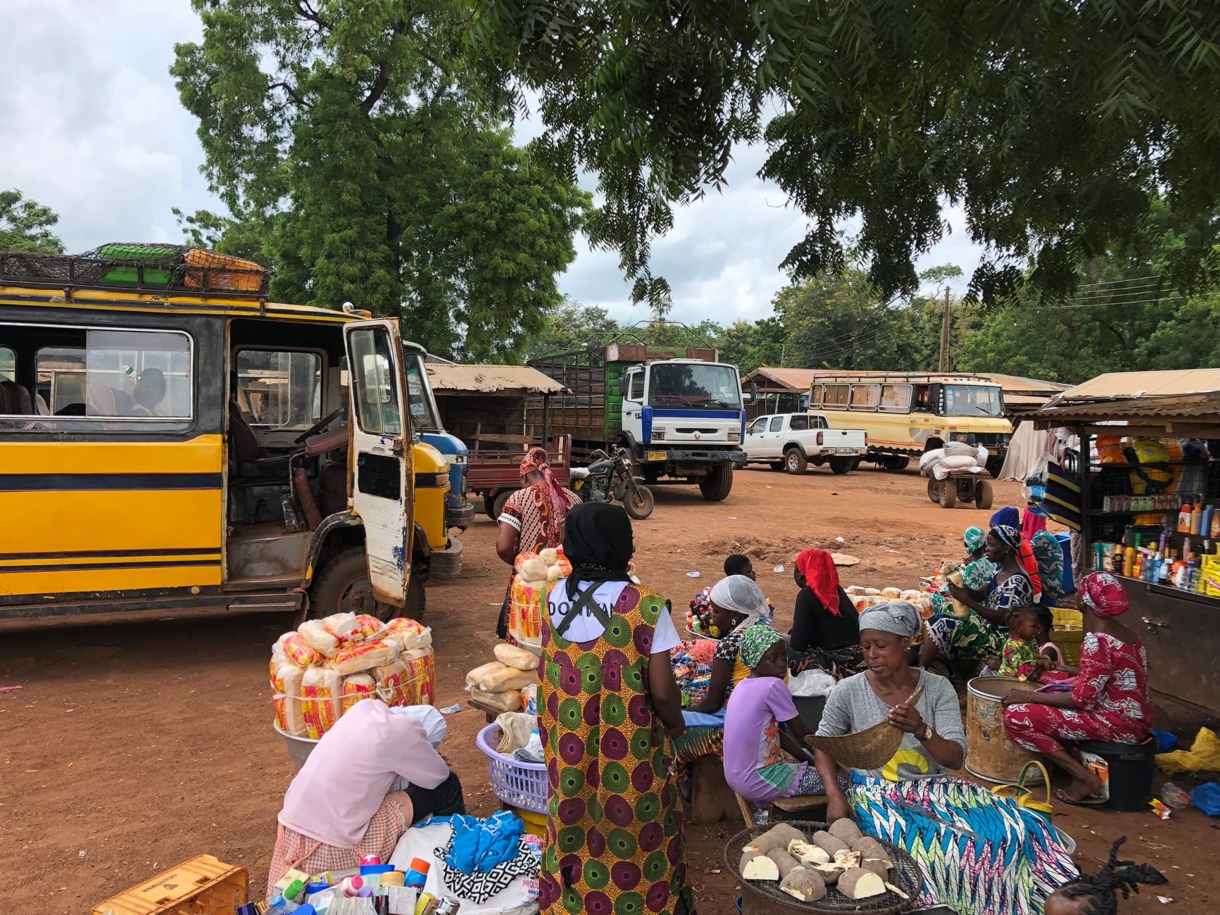 Sprawling outdoor trade stalls and open-air covered market pavilions in the historic Ashanti commercial center of Kumasi
