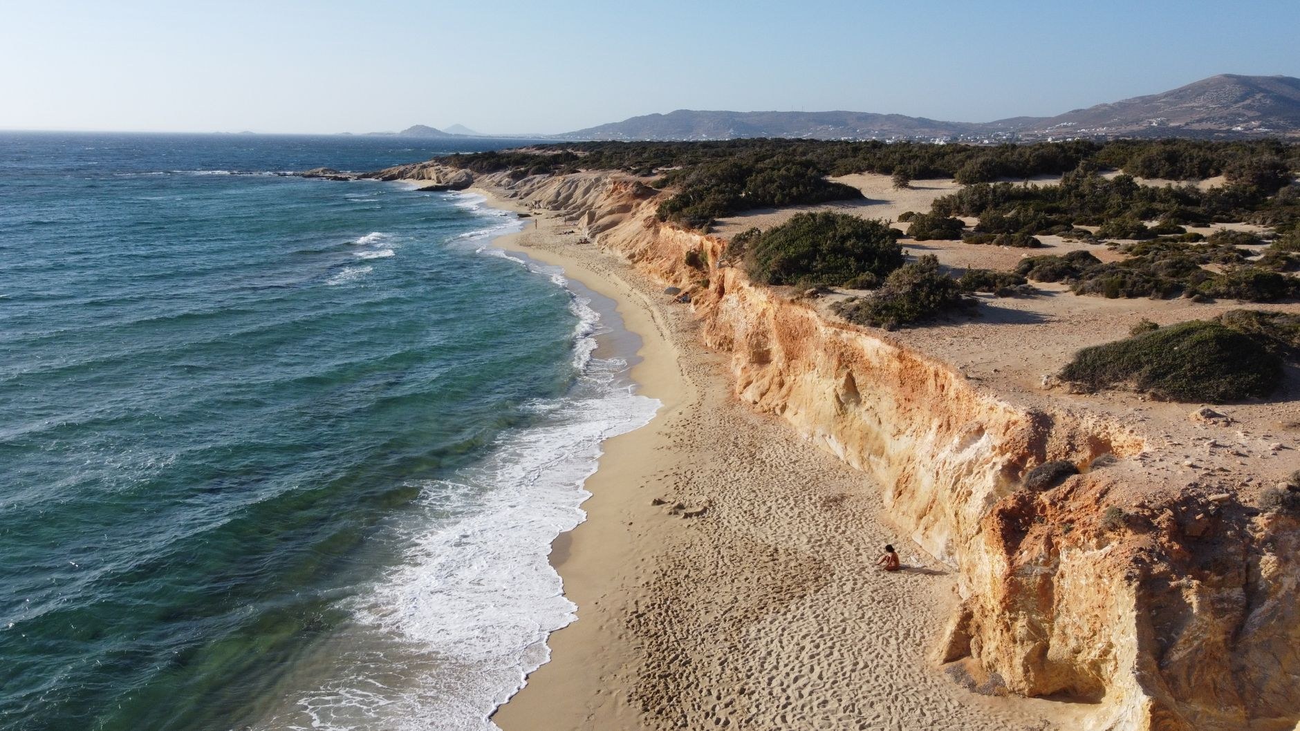 Wide golden sand beach and crystal-clear turquoise waters in Naxos