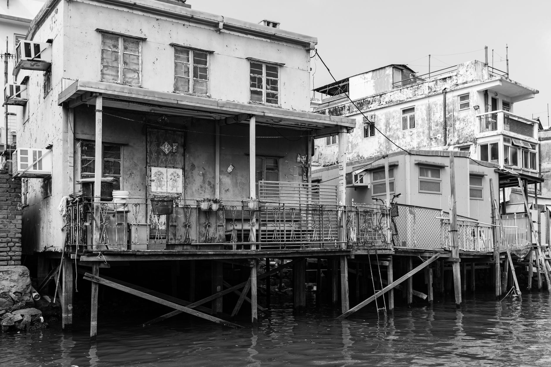 Traditional wooden stilt houses and fishing sampans lining the tranquil tidal waterways of Tai O on Lantau Island