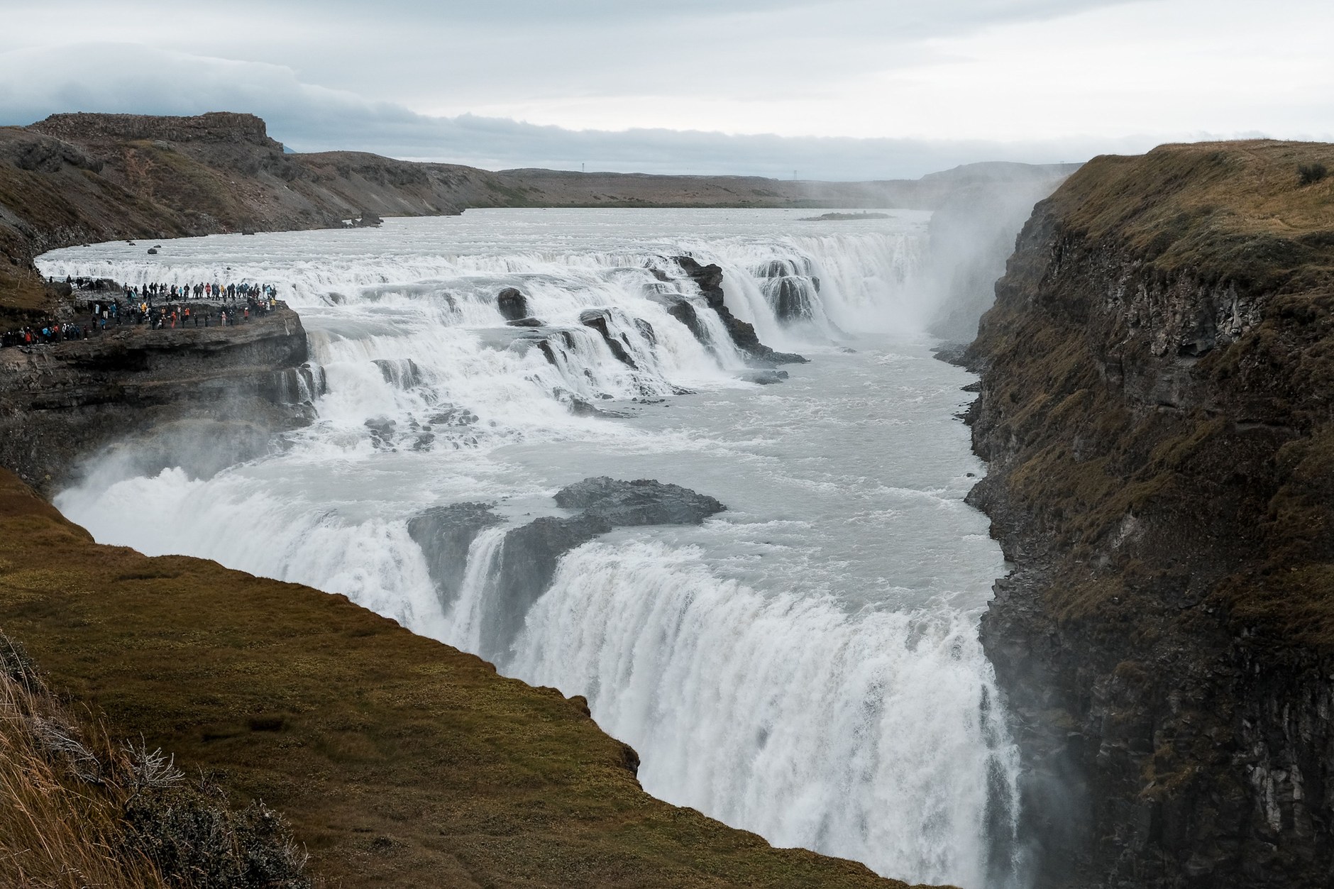 The two-tiered cascade of Gullfoss roaring into the rugged Hvítá river gorge