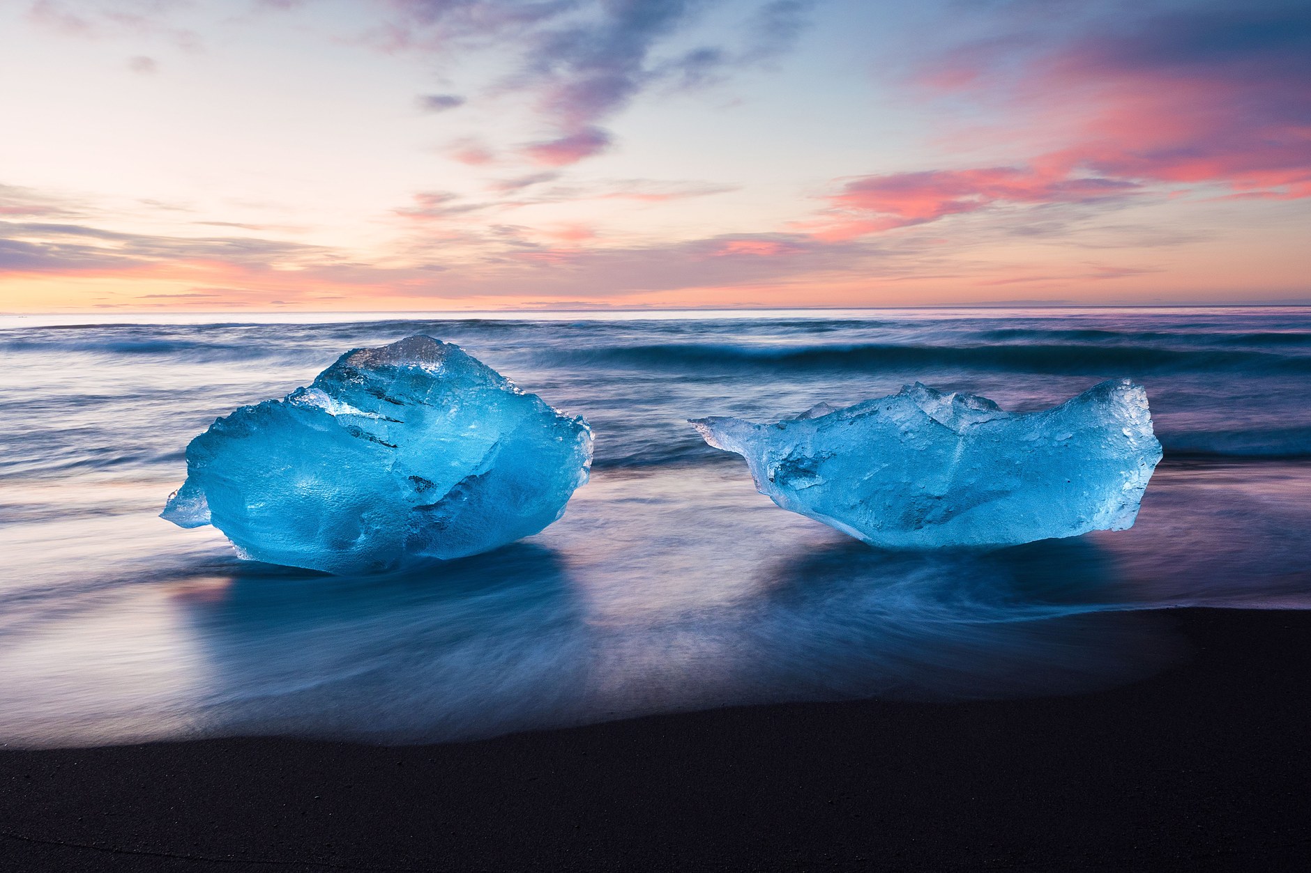 Deep blue ancient icebergs floating through the glacial waters of Jökulsárlón Glacier Lagoon