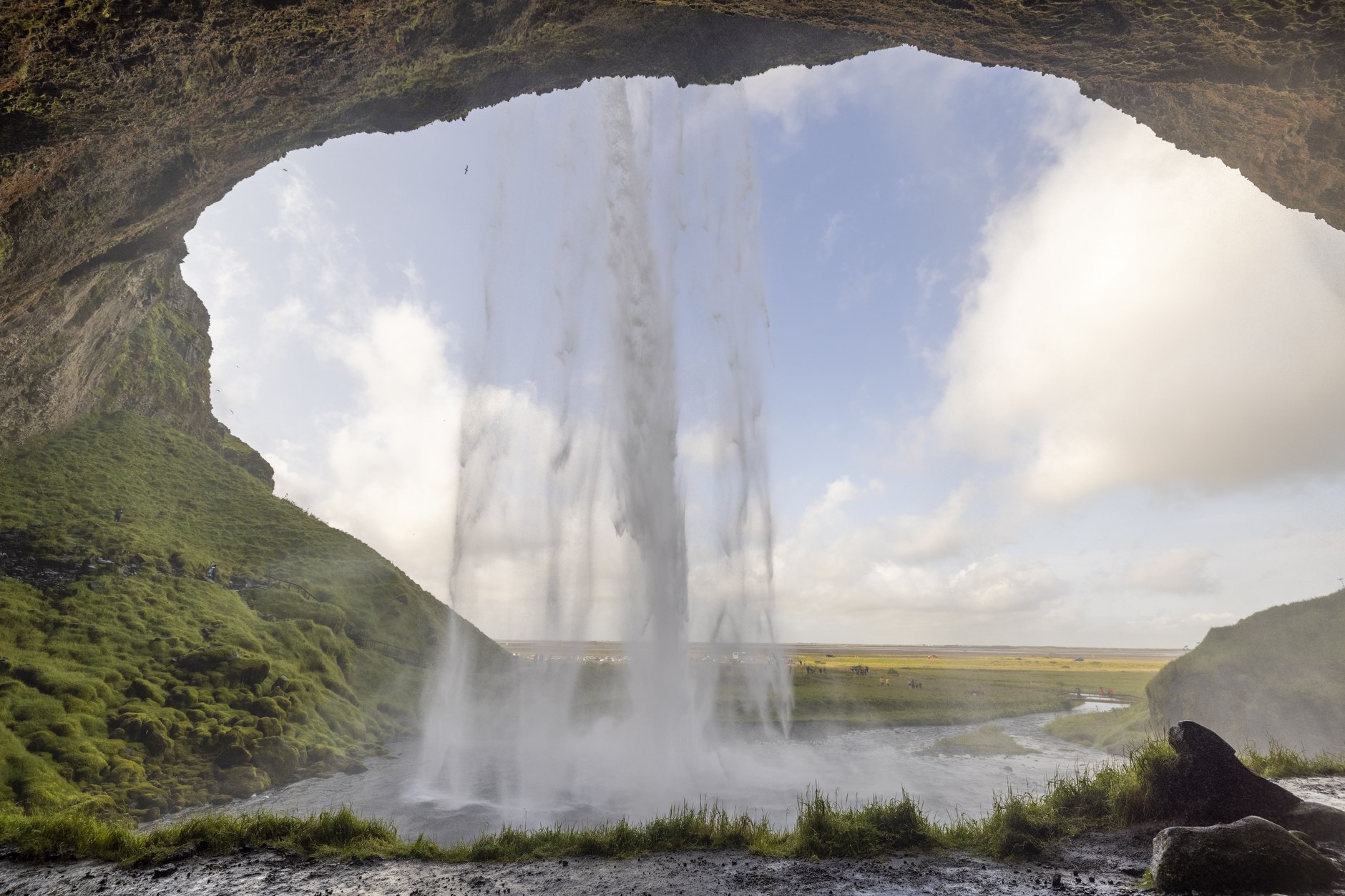 The walking trail looping directly behind the cascading curtain of Seljalandsfoss
