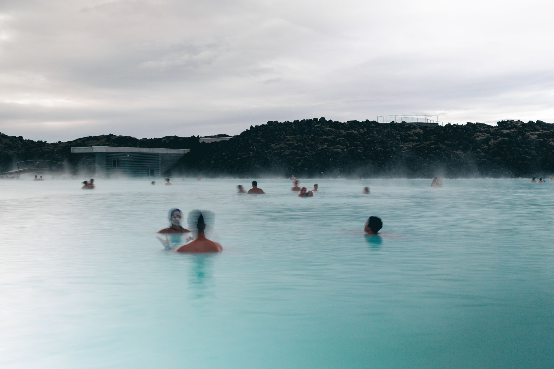 Bathers relaxing in the oceanside geothermal infinity pool at Sky Lagoon overlooking the North Atlantic