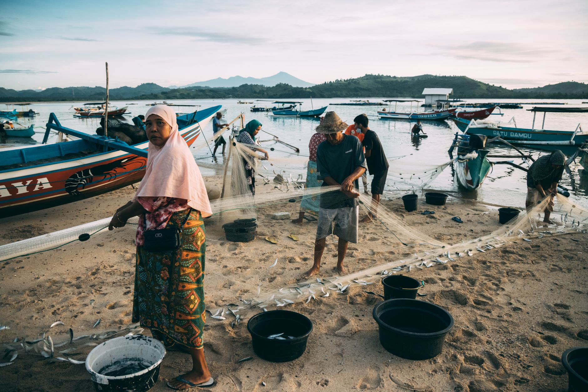 Traditional wooden outrigger boats resting on tropical shore