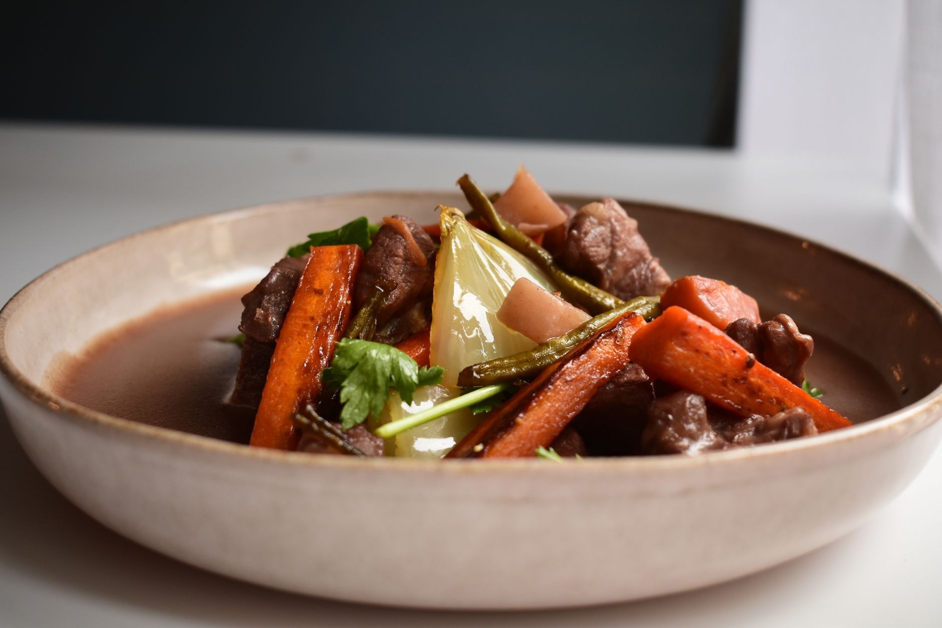 Hearty traditional Irish beef and Guinness stew served with crusty brown soda bread and fresh herbs