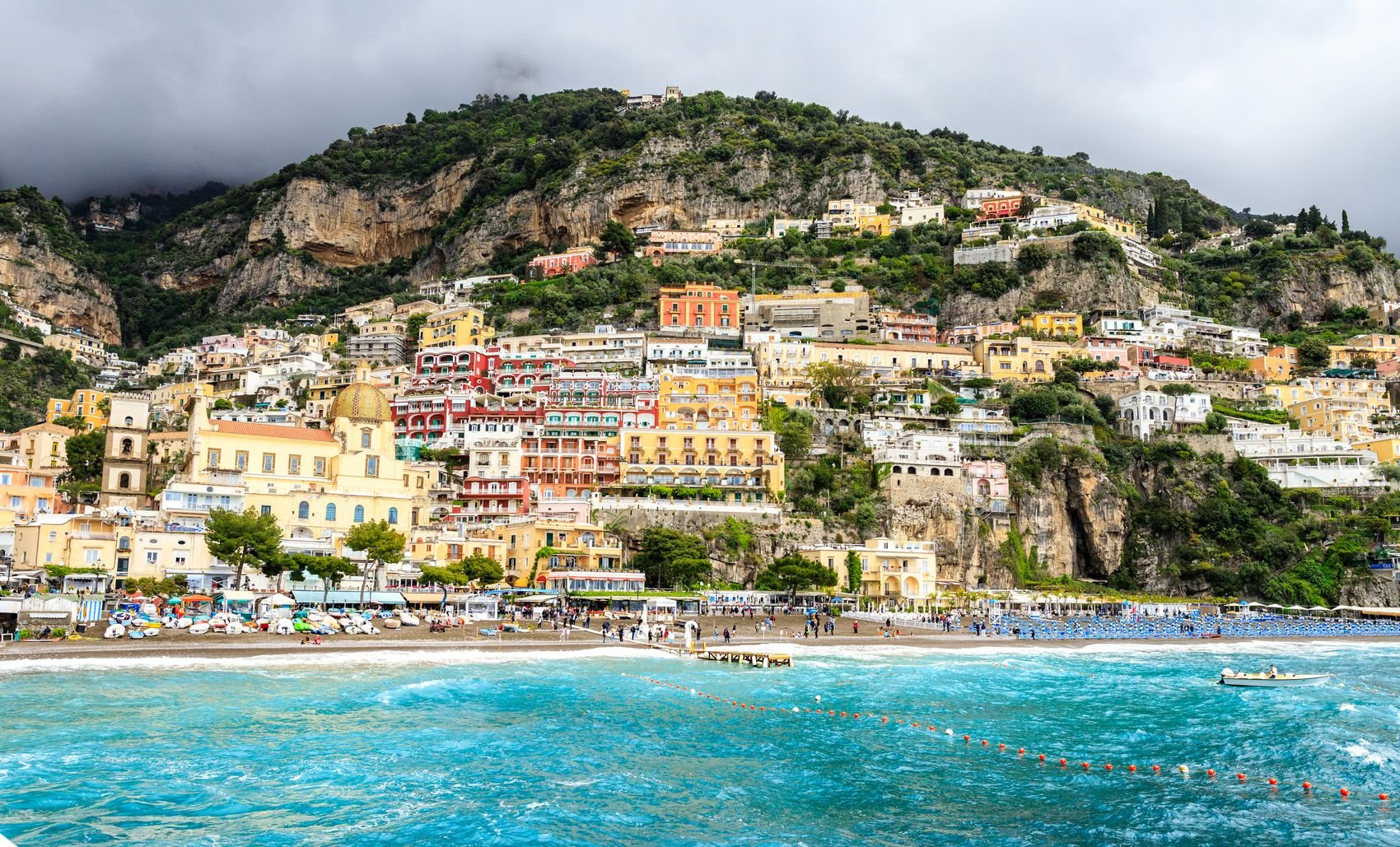 Positano’s colorful buildings rising above the beach