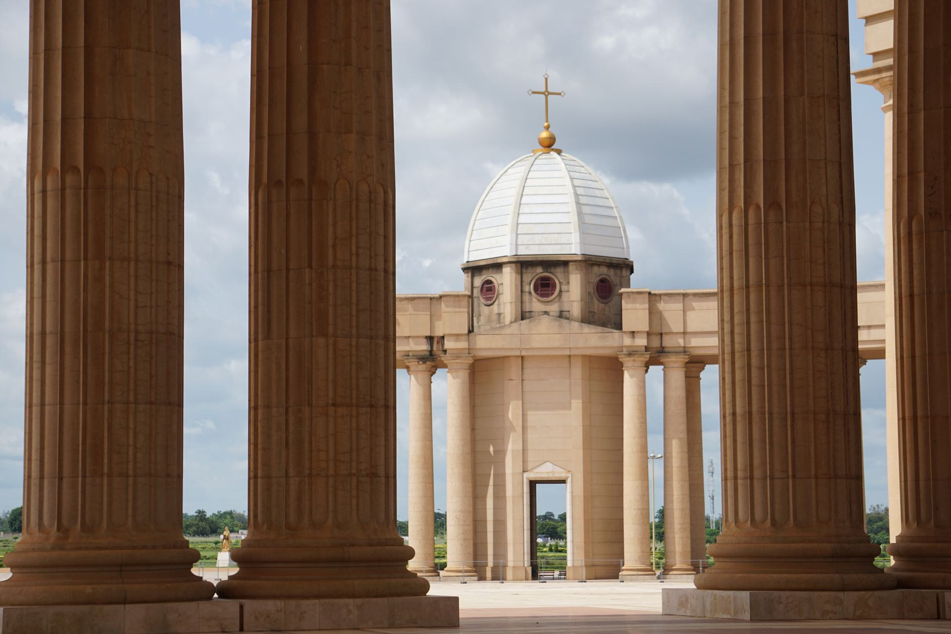 Monumental circular colonnade and granite plaza surrounding the Basilica of Our Lady of Peace