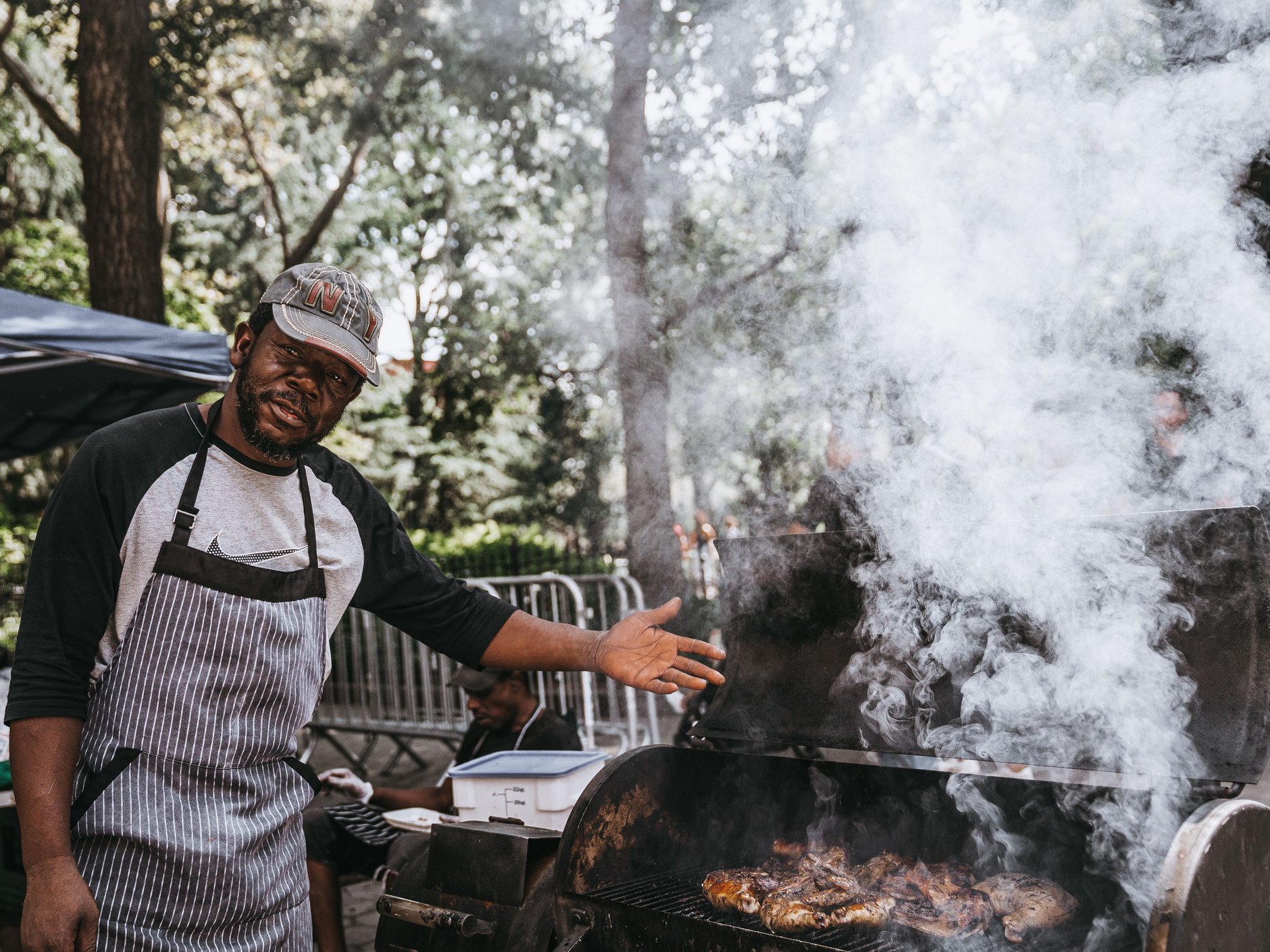 Pimento wood-fired open barbecue pit smoking seasoned jerk chicken and pork in Boston Bay Jamaica