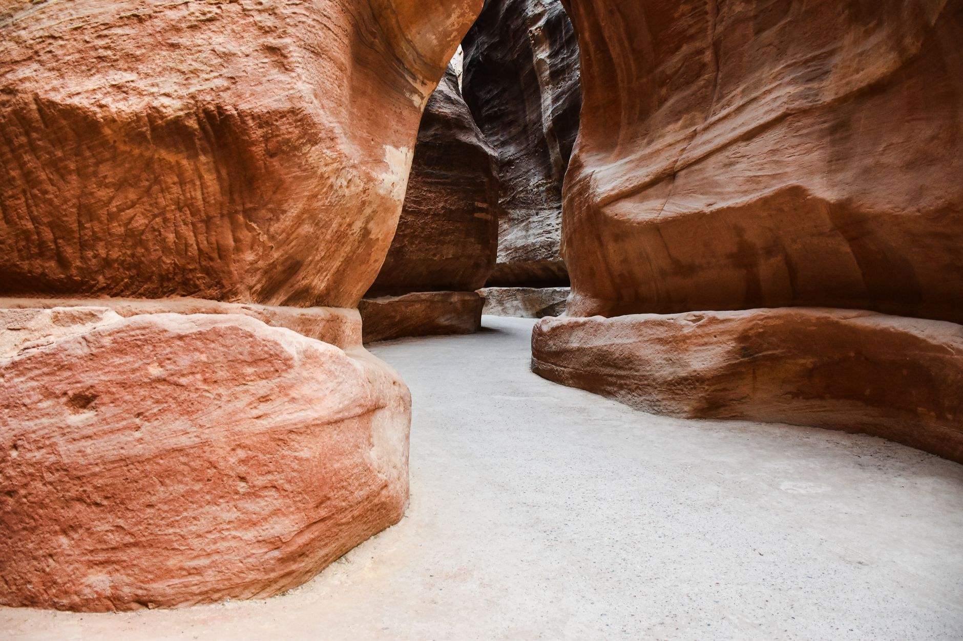 Dramatic towering sandstone gorge leading travelers into Petra