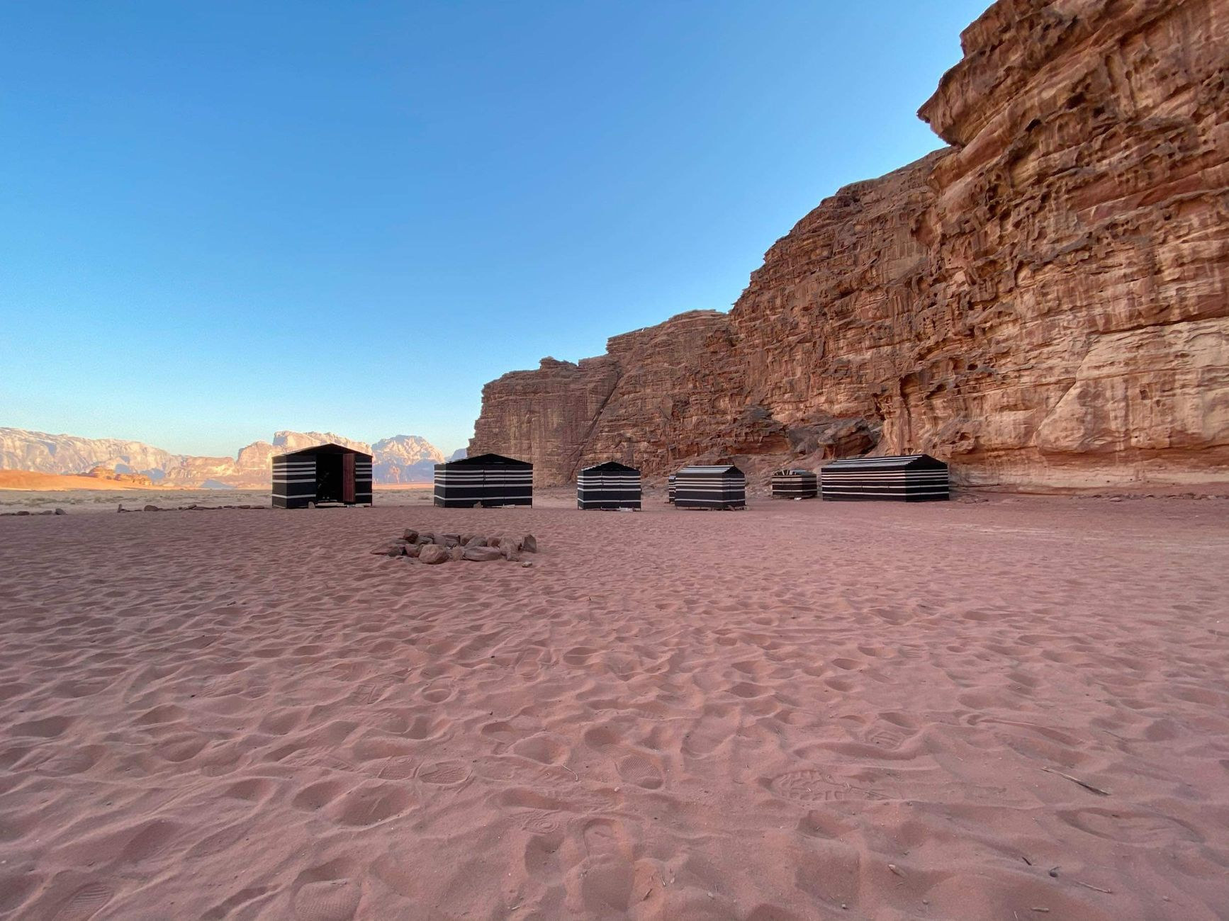 Traditional desert camp nestled against sandstone cliffs in Wadi Rum