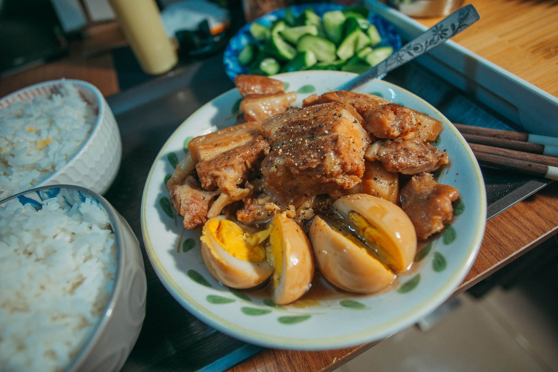 Traditional Kazakh beshbarmak platter with boiled tender meat, broad flat noodles, onion broth, and puffy golden baursaks