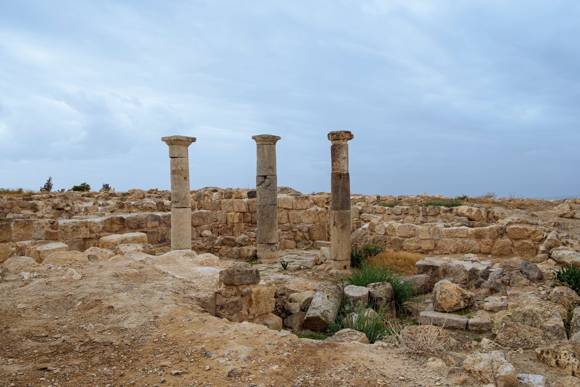 Weathered stone walls and foundations of Bronze Age and Hellenistic settlements in the desert of Failaka Island