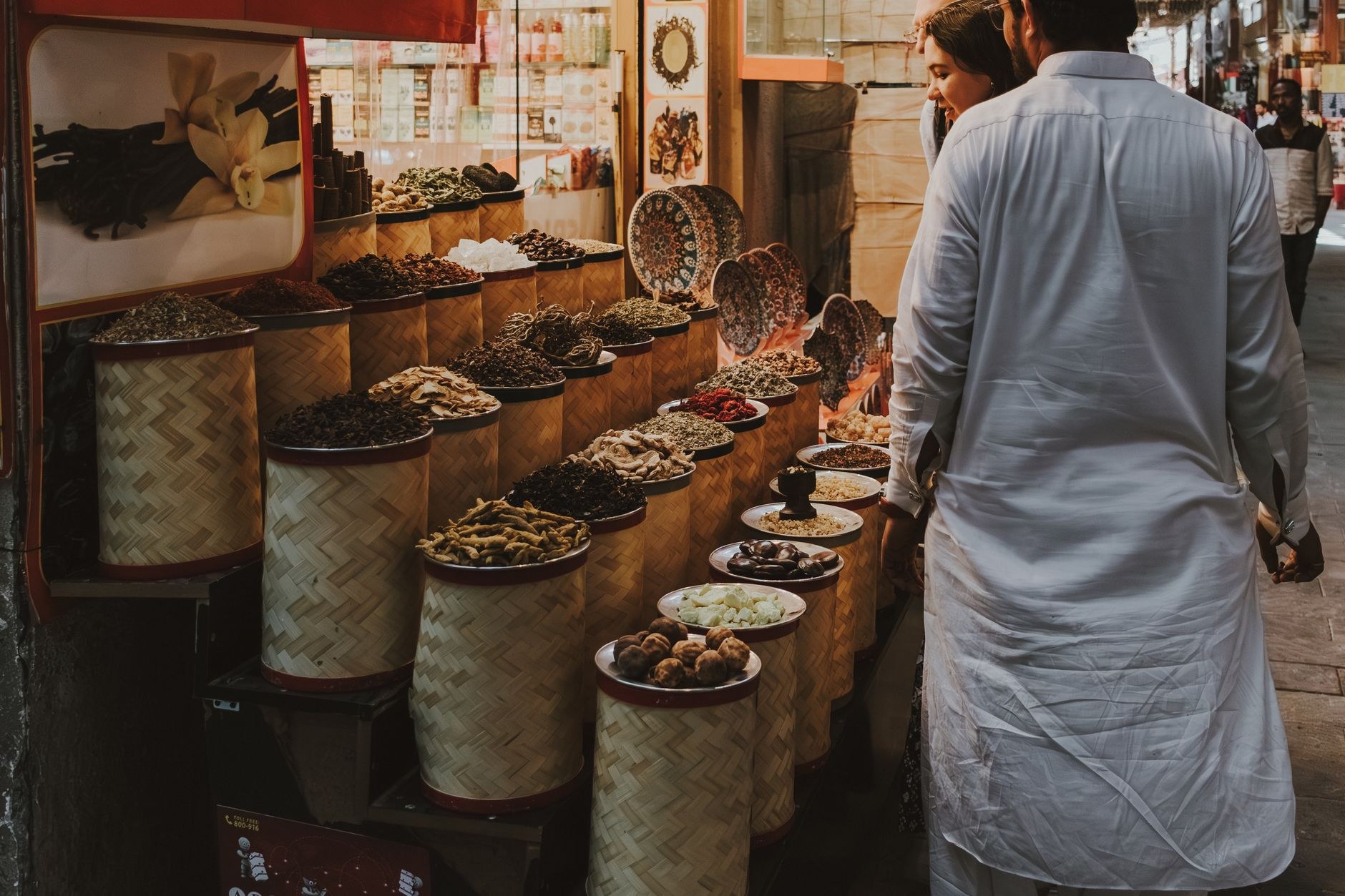 Shaded wooden arcade alleyways lined with colorful pyramids of fragrant Middle Eastern spices and dried dates