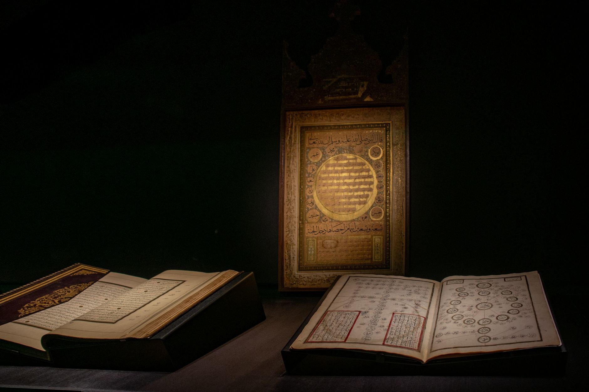 Exquisite antique silver jewelry, ceremonial daggers, and illuminated Quranic manuscripts on museum display
