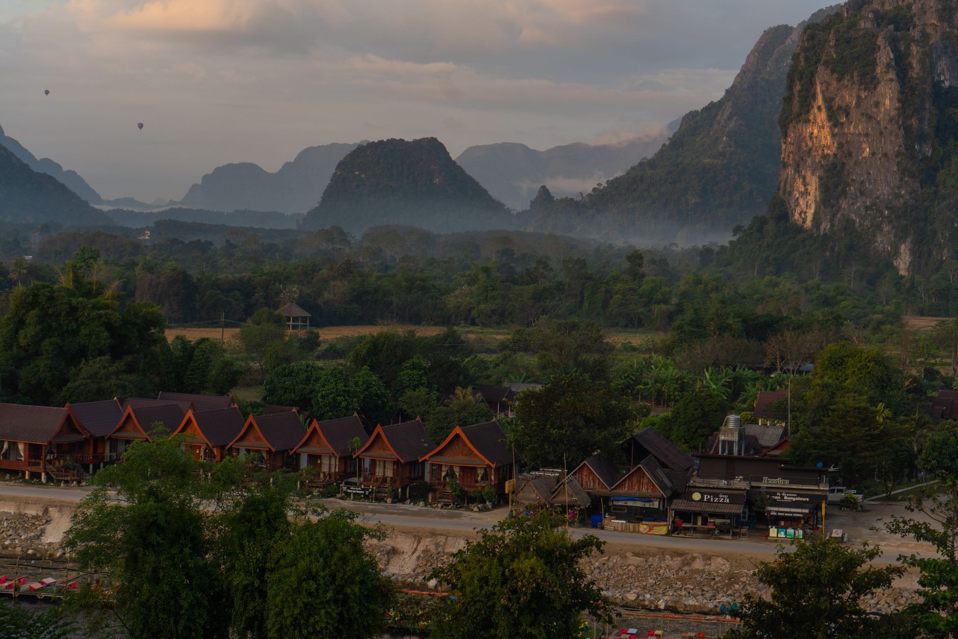 Towering limestone karst peaks reflecting in the tranquil waters of the Nam Song River in Vang Vieng