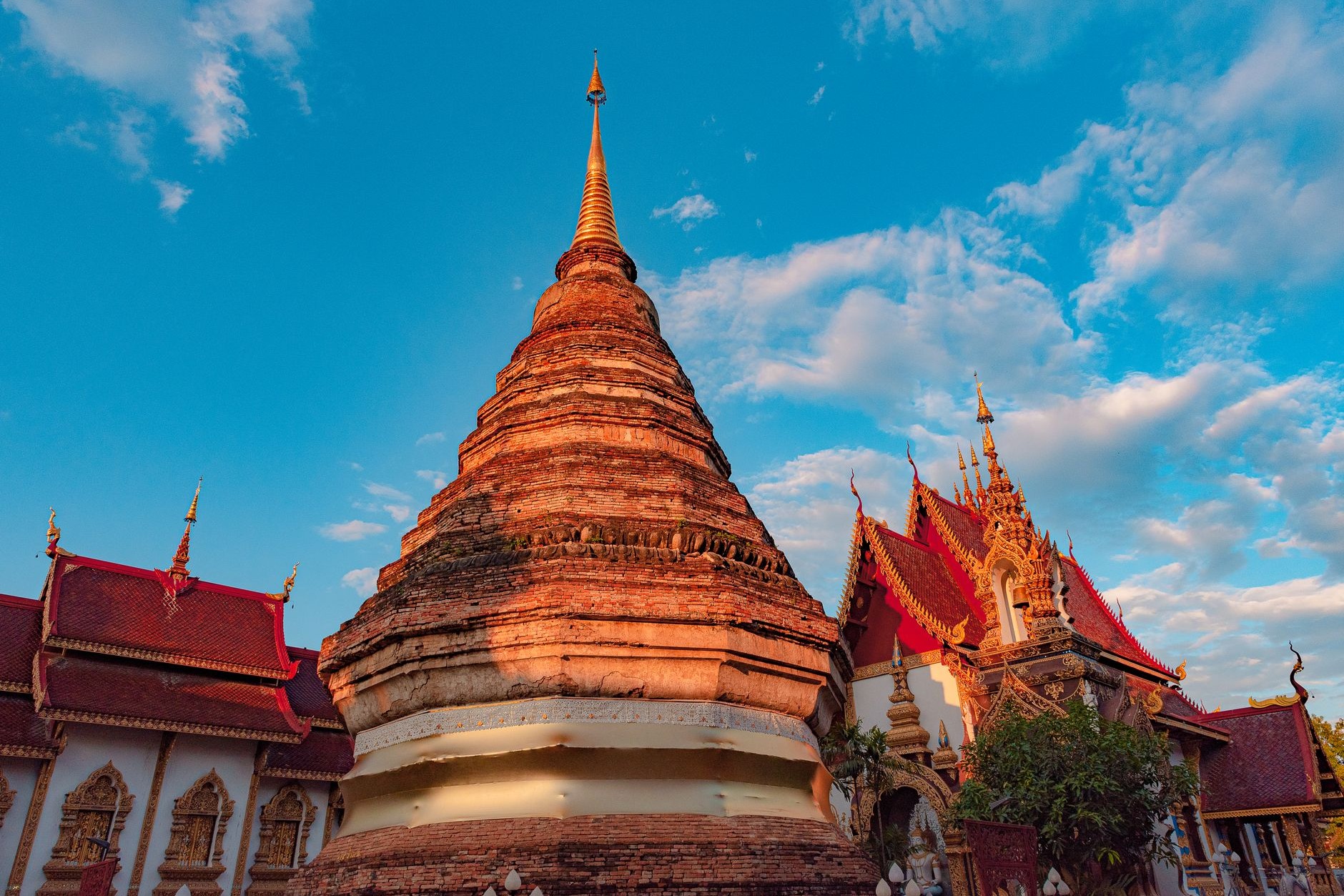 Colossal 44-meter gold-covered sacred stupa of Pha That Luang glowing under clear blue skies in Vientiane