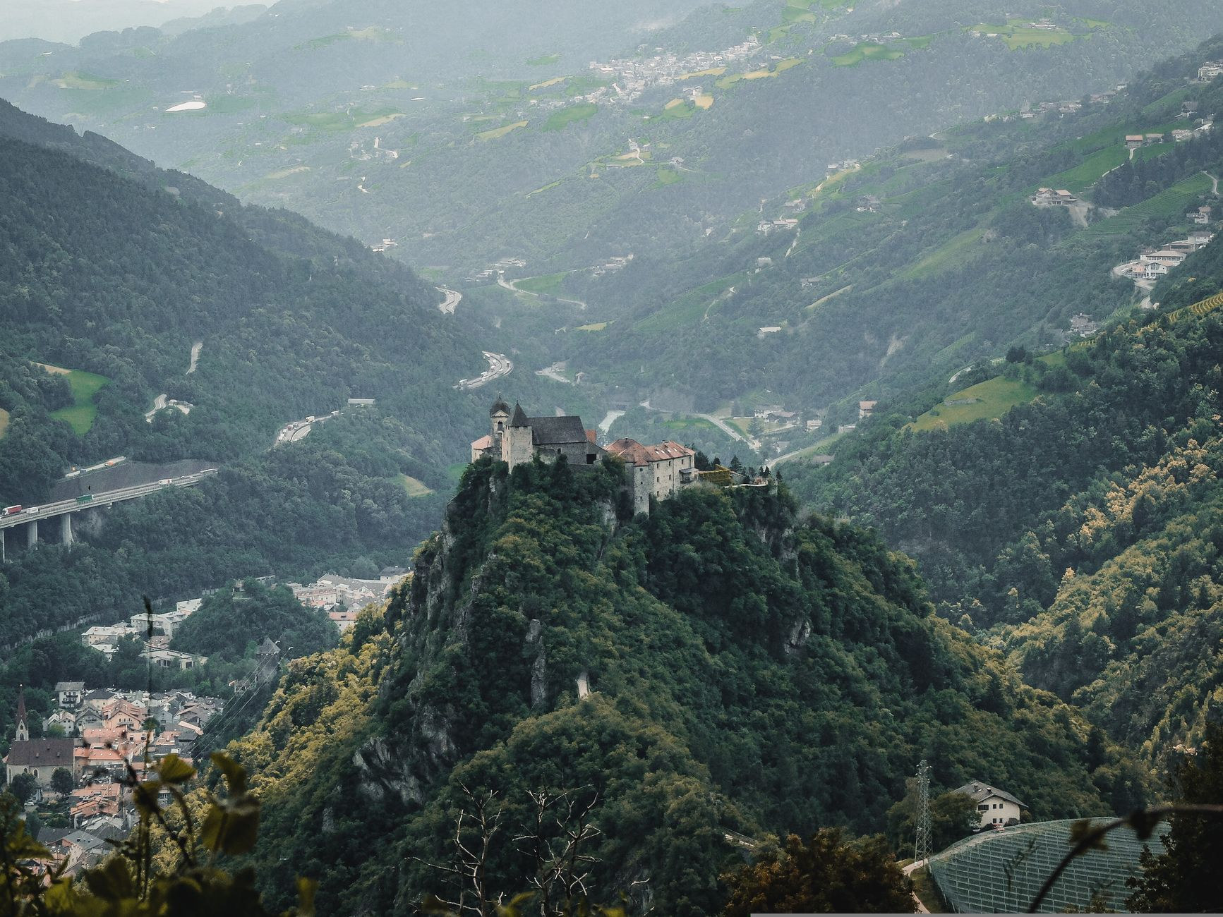 High angle aerial perspective of medieval Gutenberg Castle standing proudly on a free-standing rocky hill in Balzers