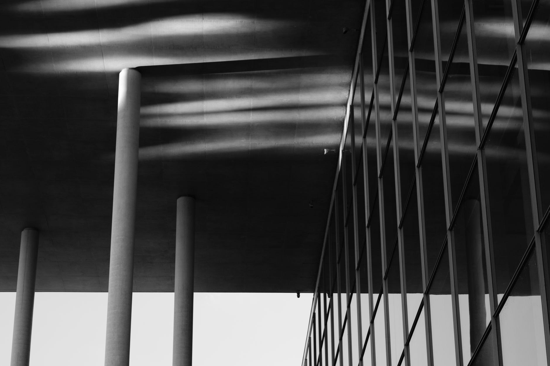 Futuristic white curving colonnade and glass facade of the Philharmonie concert hall on the Kirchberg plateau