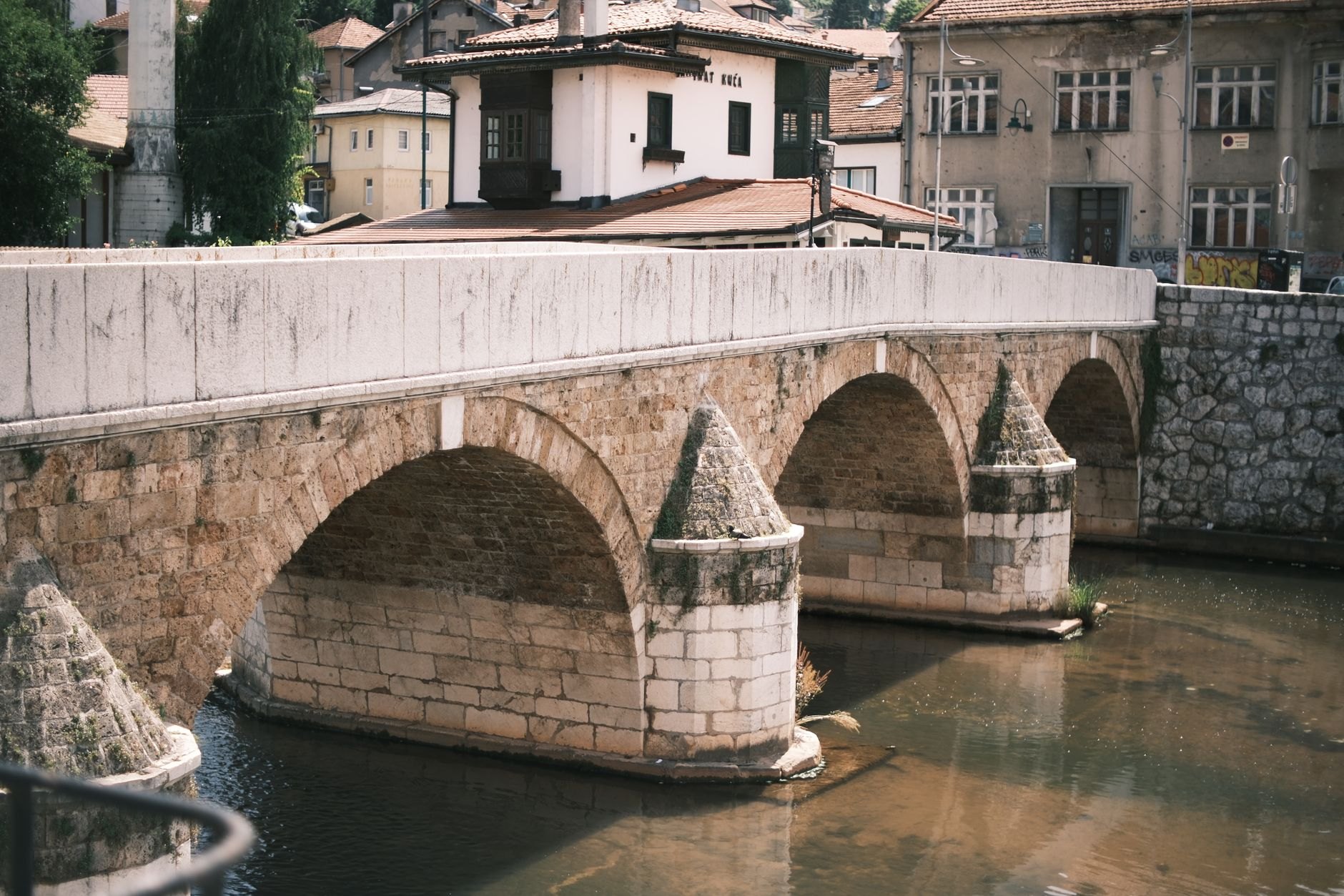 Historic multi-arched Ottoman Stone Bridge spanning the Vardar River in central Skopje