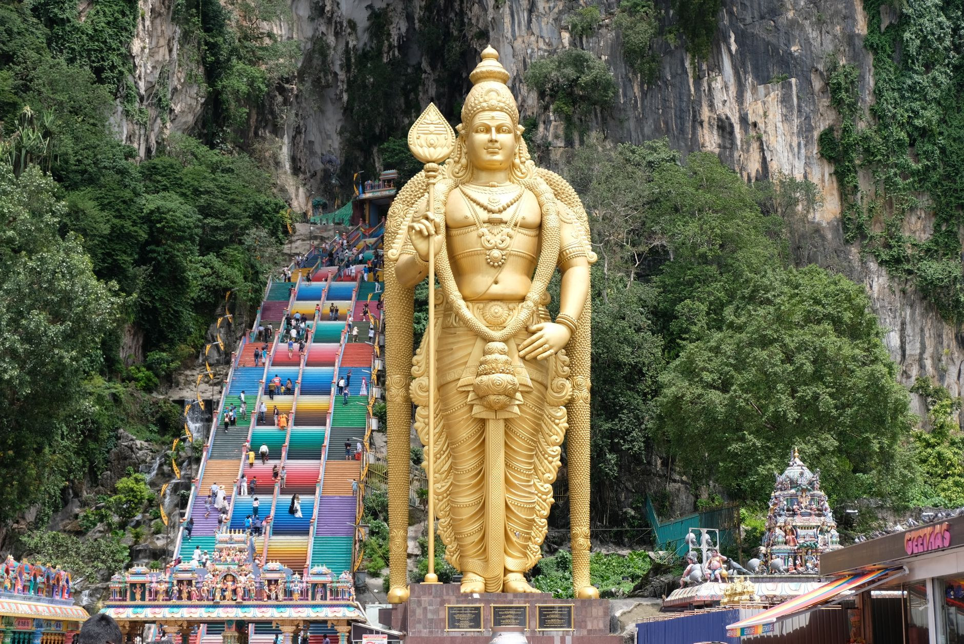 Colossal golden Murugan statue and vibrant stairs at Batu Caves