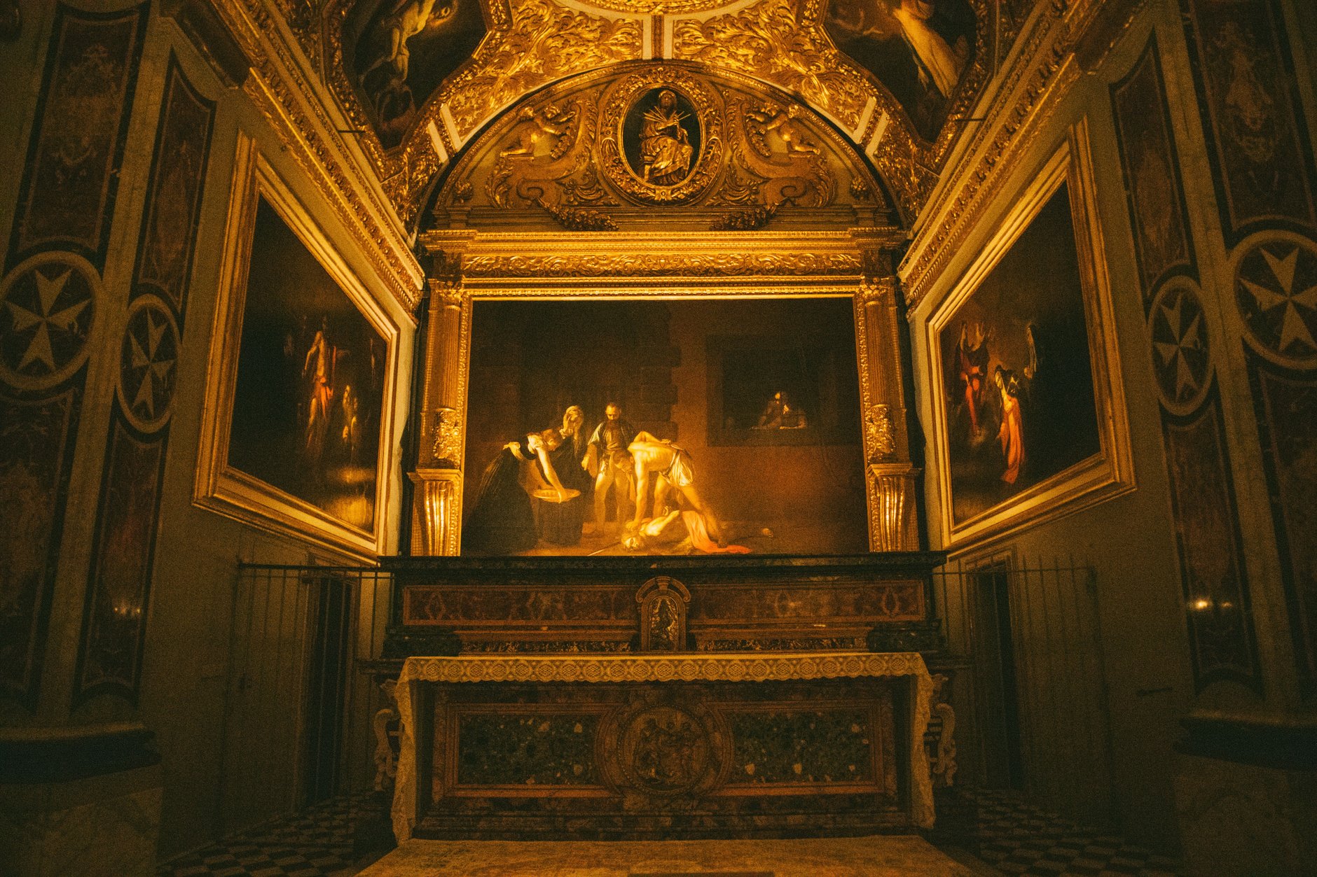 Intricately carved gilded high baroque interior and carved stone walls inside St Johns Co-Cathedral in Valletta Malta