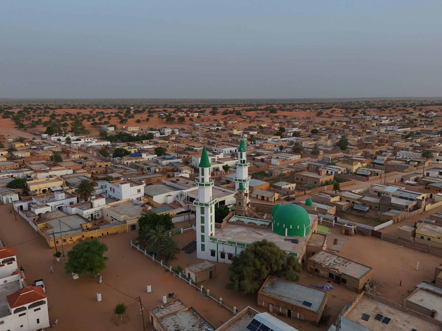 Aerial perspective over a historic desert mosque and traditional mud-and-stone architecture in Mauritania