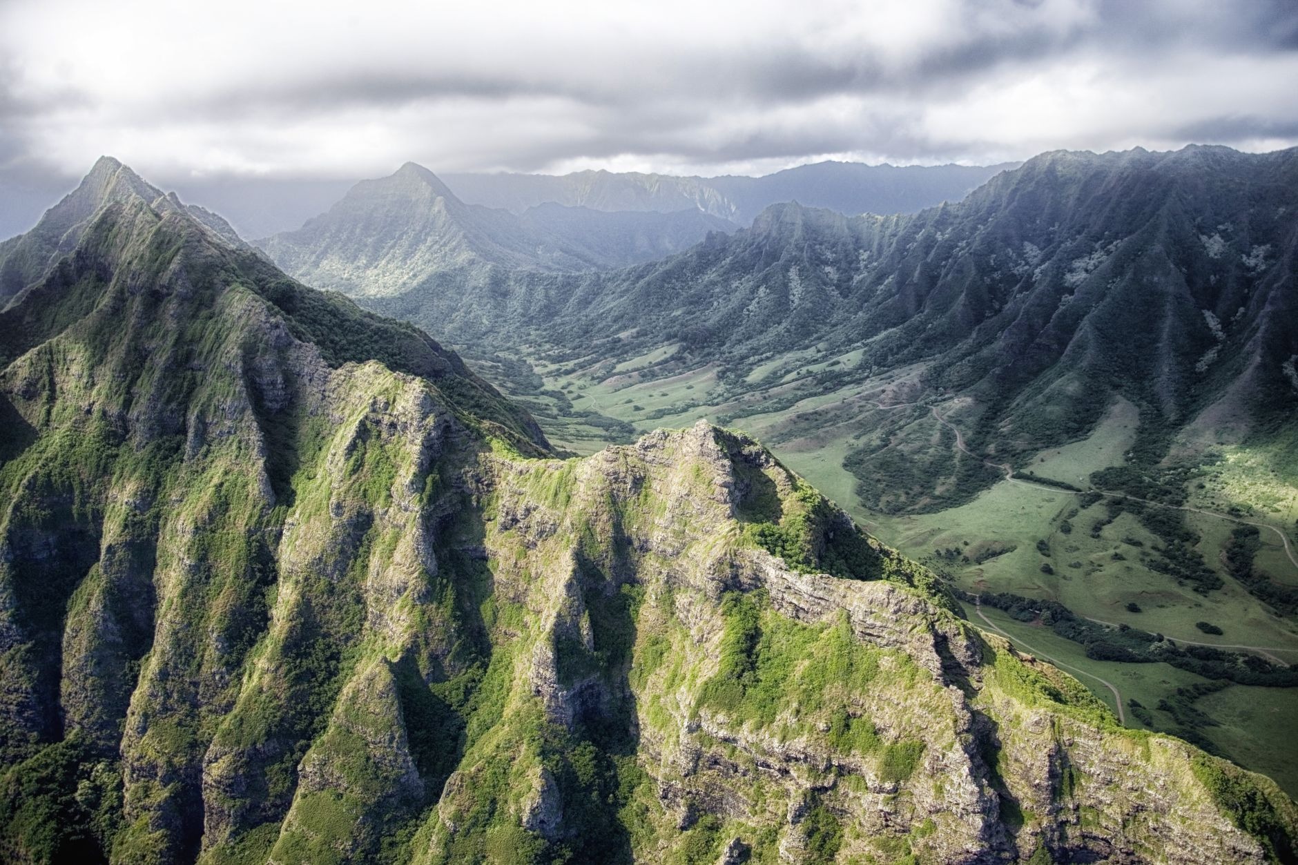 Expansive scenic vista over the dense rainforest canopy and rugged volcanic ridgelines of Black River Gorges National Park