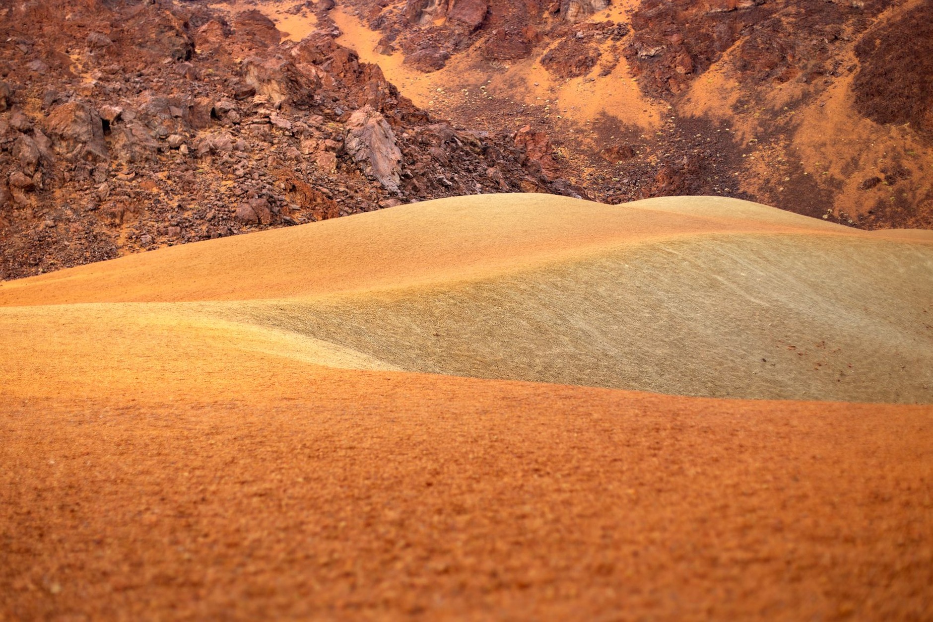 Undulating volcanic sand dunes displaying distinct mineral bands of purple, red, and violet at Chamarel Seven Coloured Earths