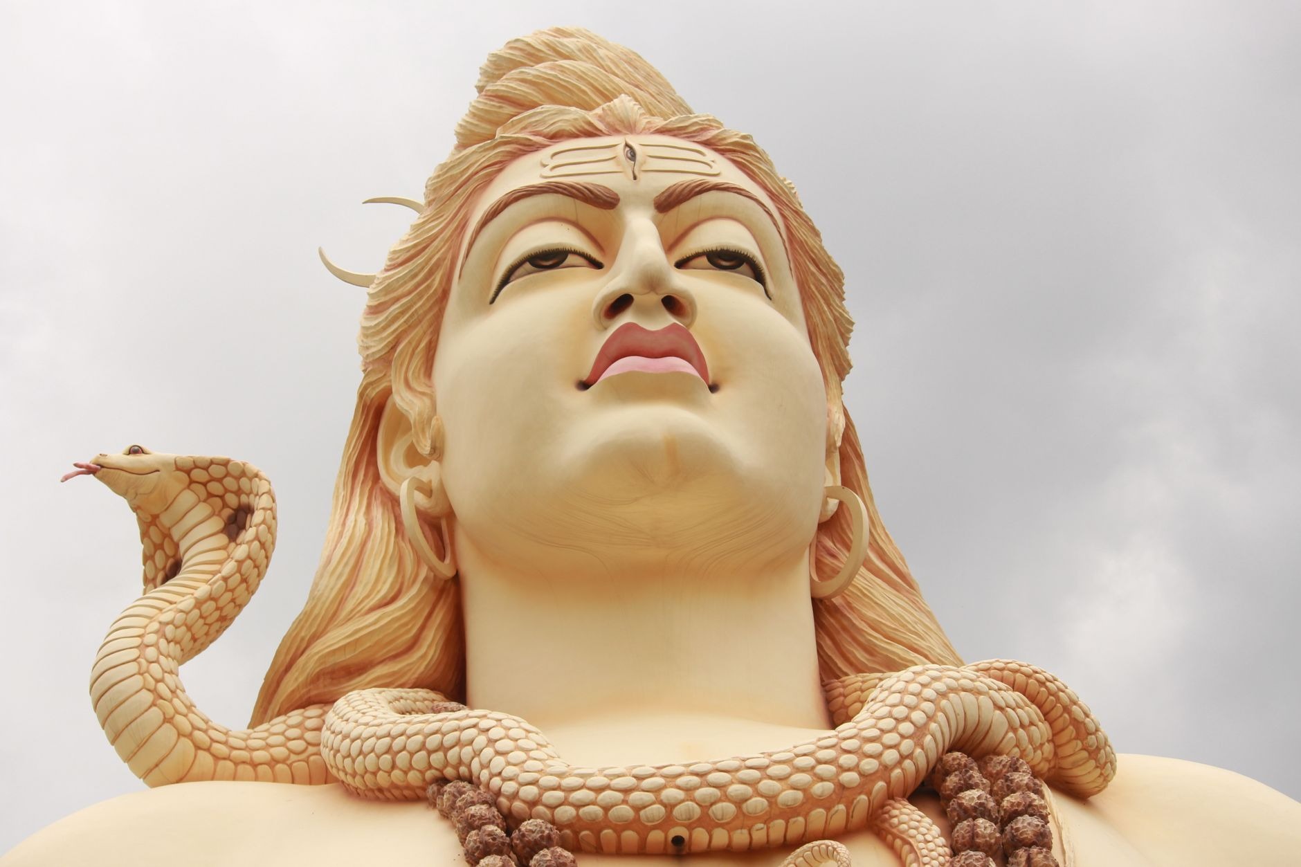 Colossal 33-meter statue of Lord Shiva standing serene beside the sacred volcanic crater lake of Ganga Talao (Grand Bassin)