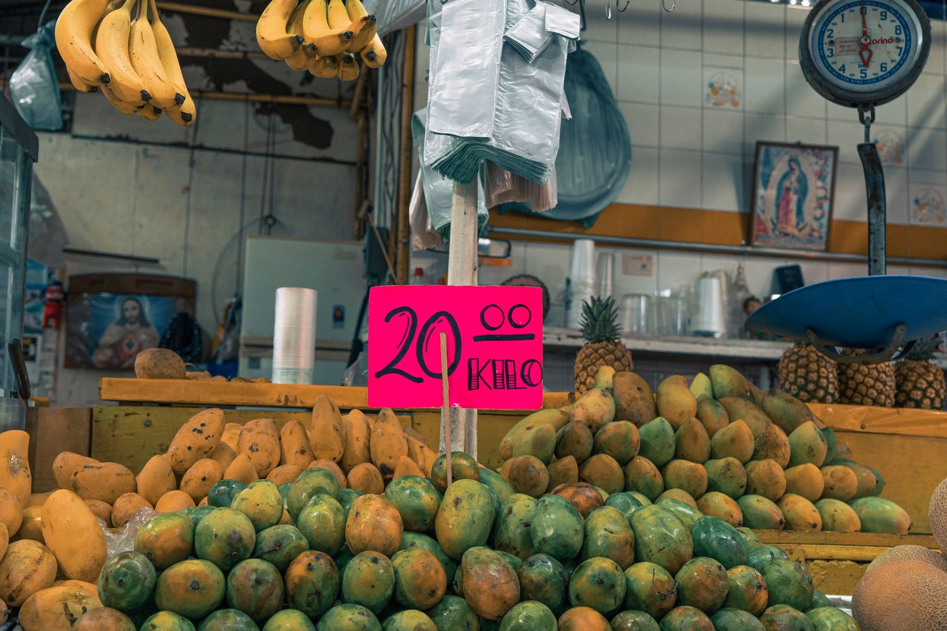 Vibrant piles of tropical pineapples, passion fruit, and bananas displayed by local merchants at Port Louis Central Market