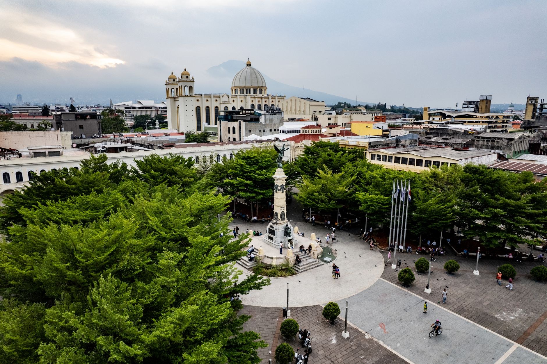A stately neoclassical cathedral with a large central dome and detached bell tower in a leafy city park