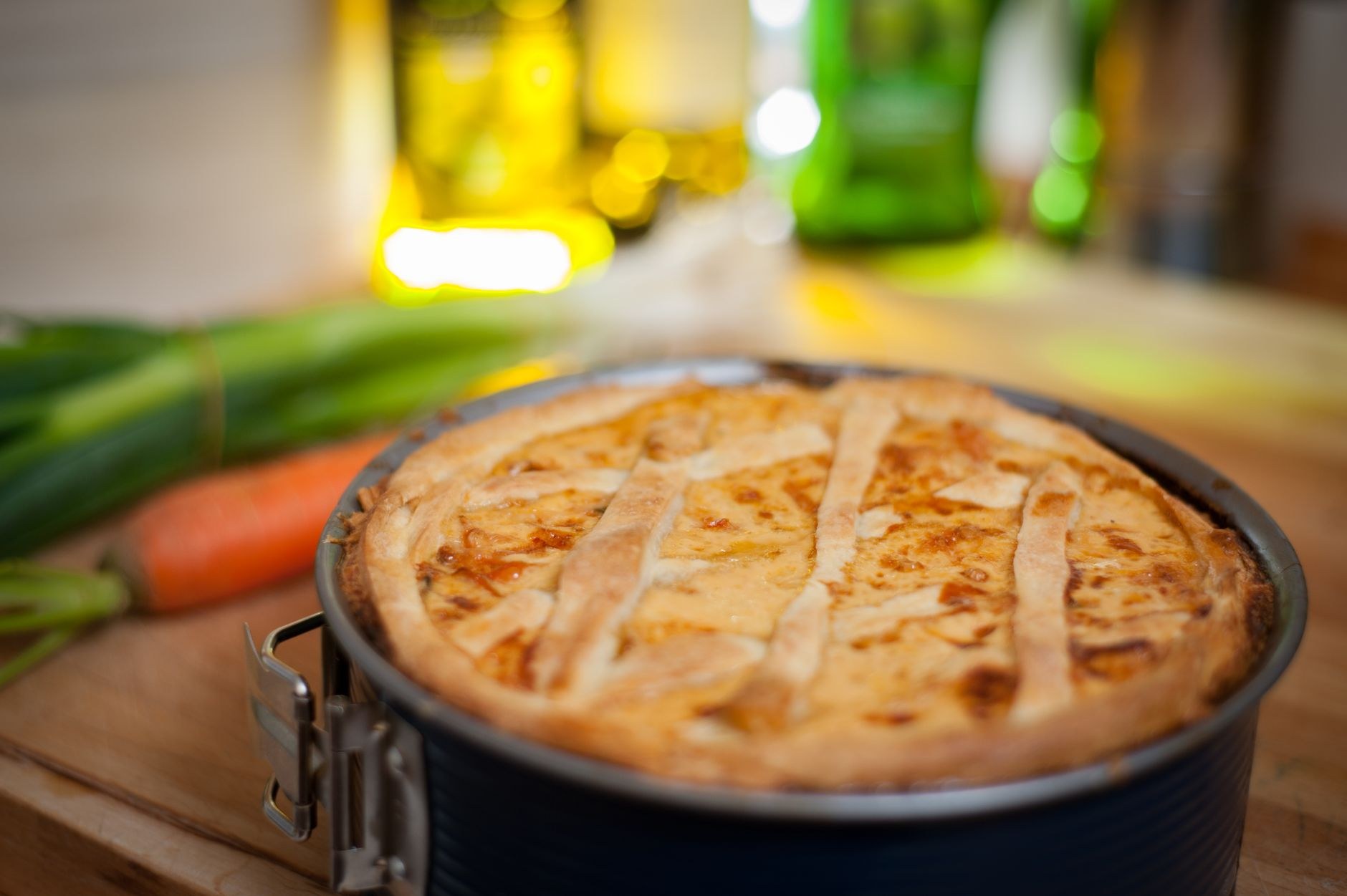 A rustic table spread with a mound of golden mămăligă, sheep's cheese, sour cream, and crispy flaky plăcinte pastries