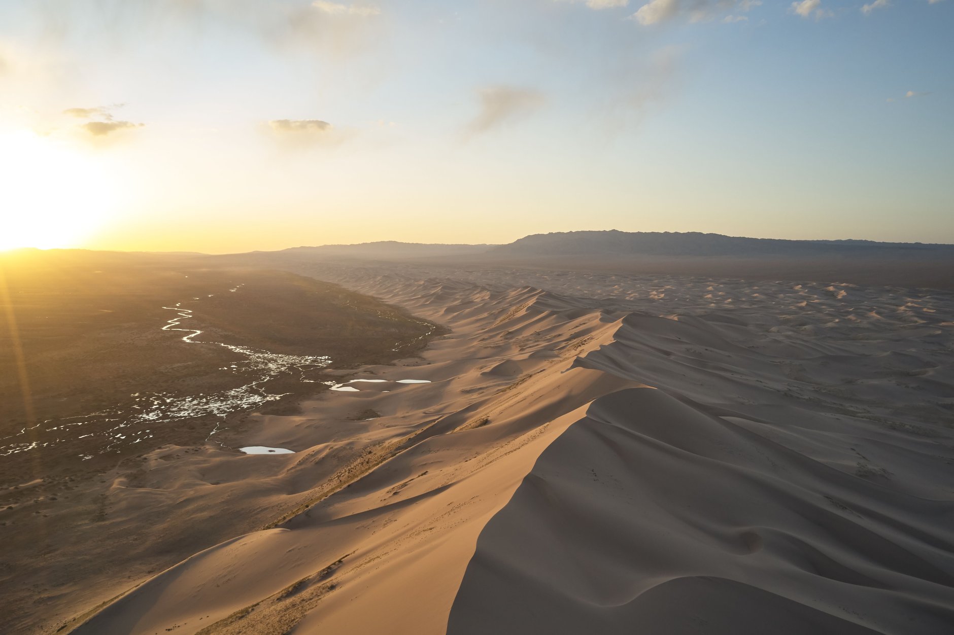 Towering wind-sculpted sand ridges of Khongoryn Els singing dunes rising three hundred meters above the Gobi Desert floor