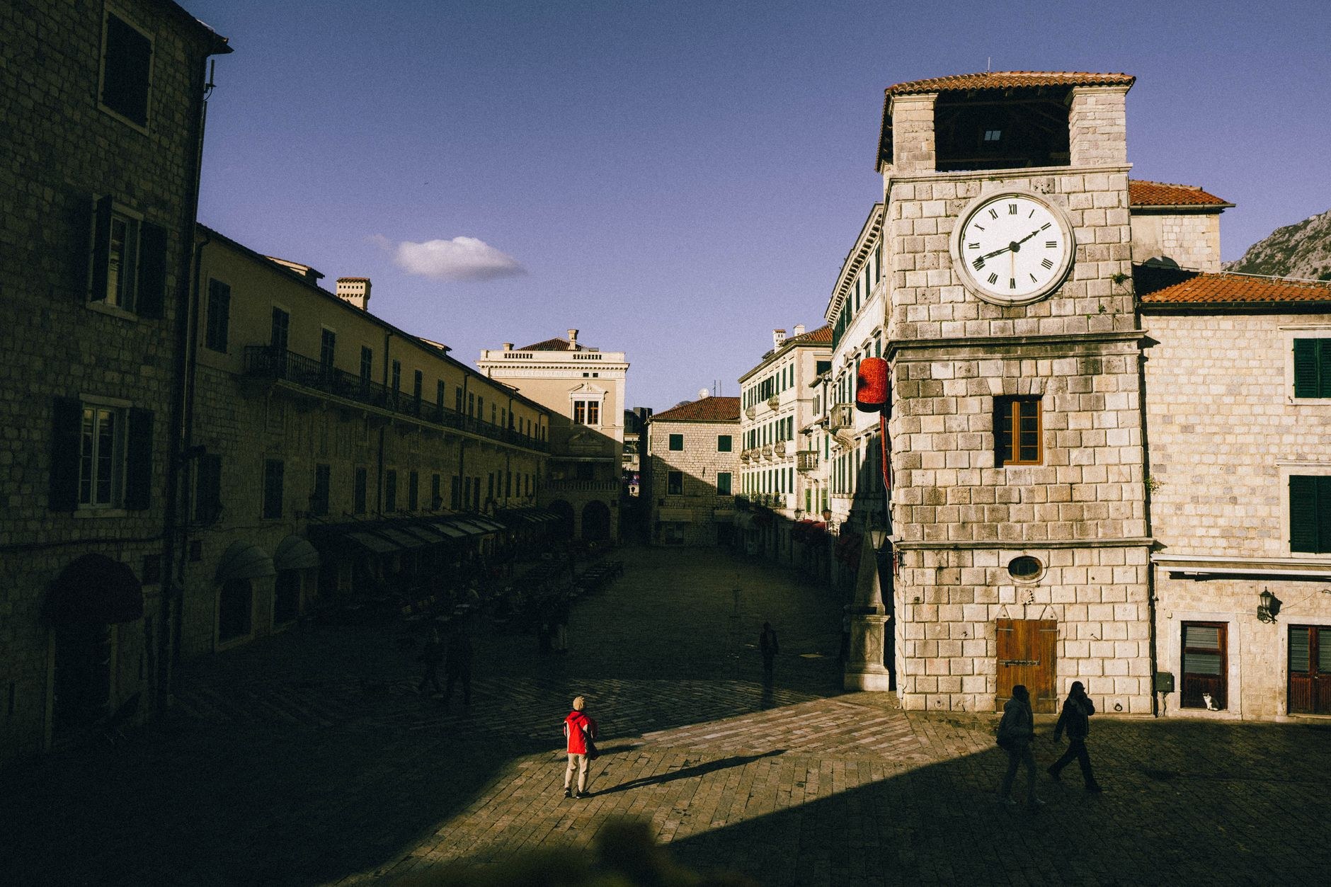 Medieval stone facades, Renaissance clock tower, and polished limestone paving in Kotor Old Town, Montenegro