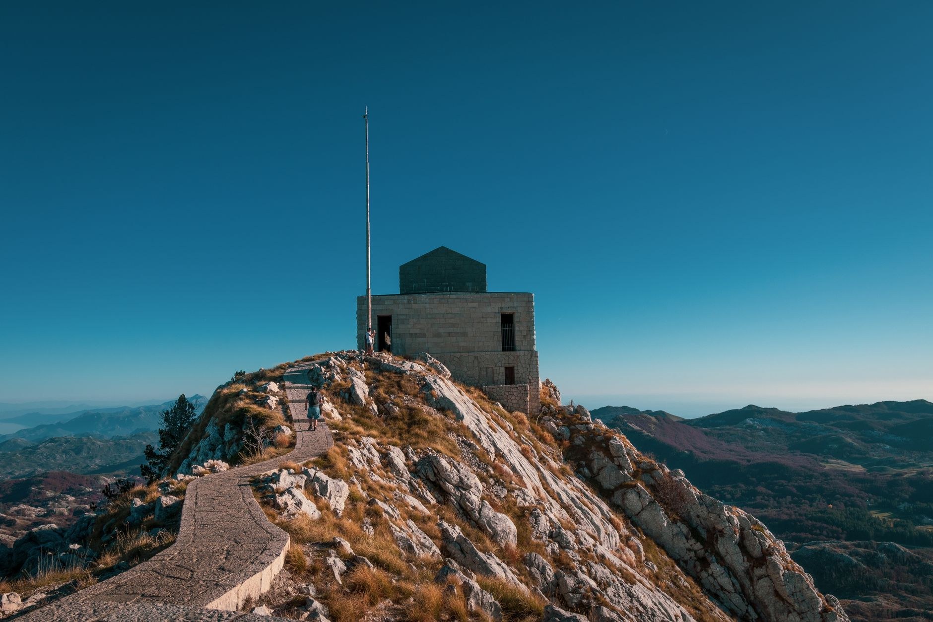 The monumental stone staircase and granite mausoleum of Petar II Petrović-Njegoš perched on the summit ridge of Mount Lovćen