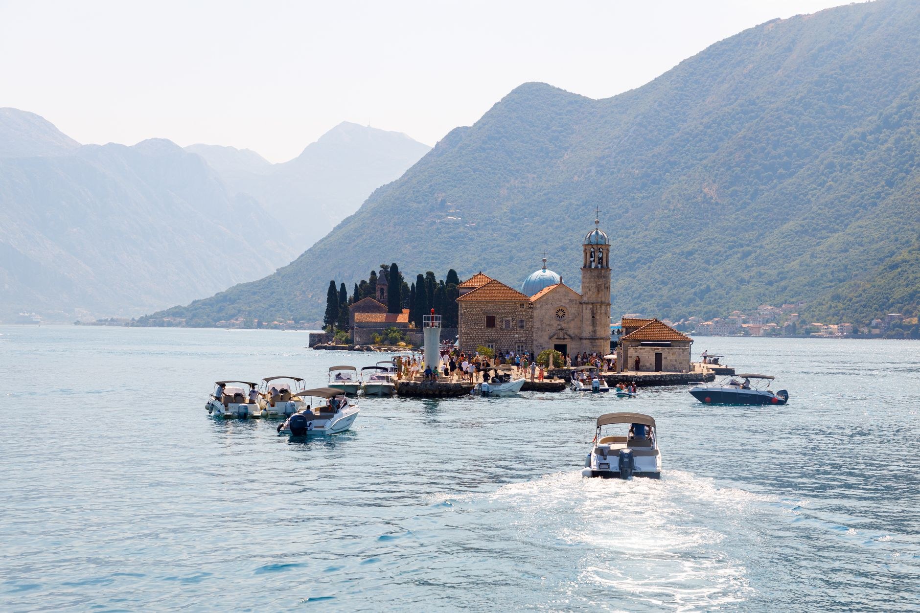 Artificial island and Roman Catholic church of Our Lady of the Rocks in the calm waters of the Bay of Kotor near Perast