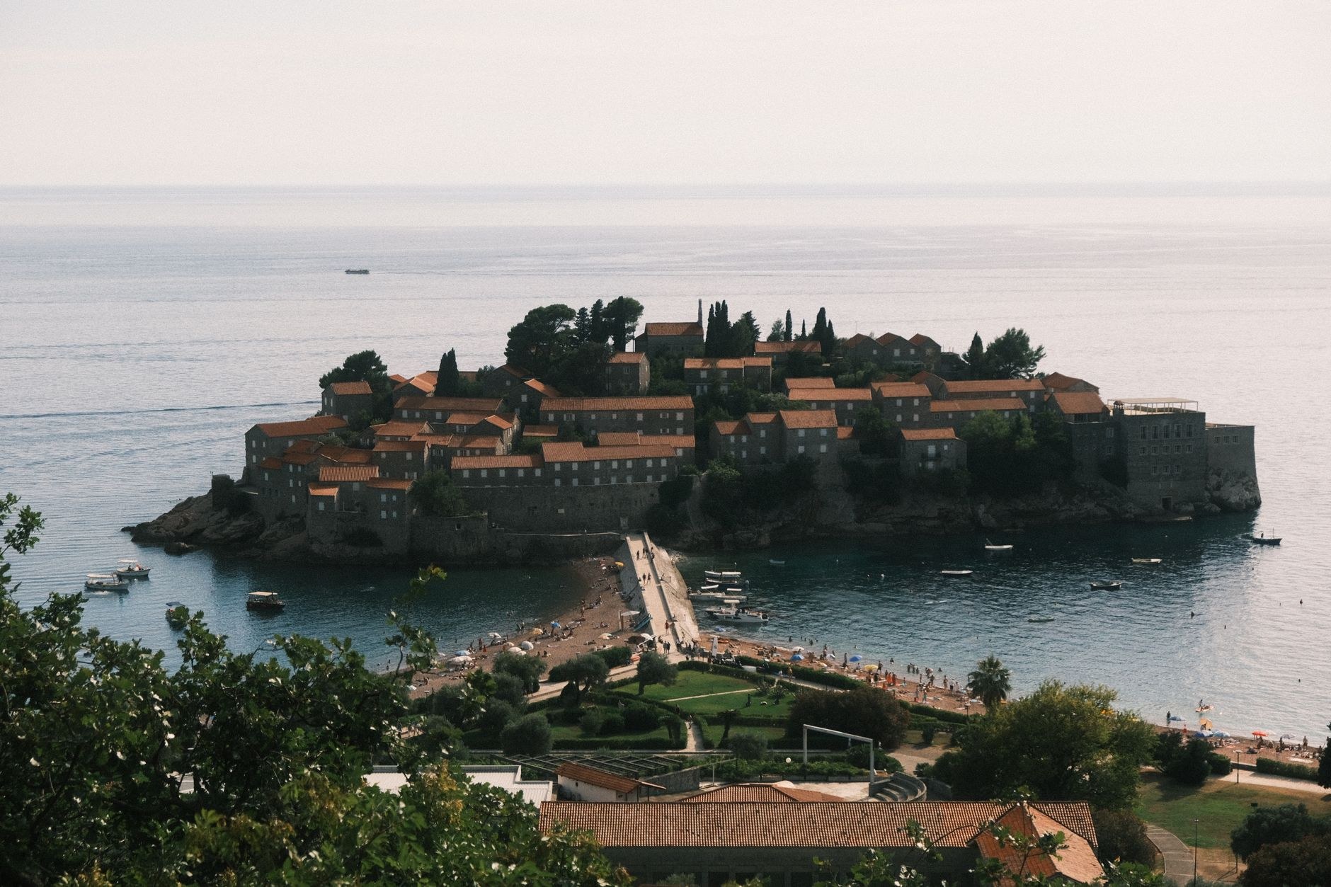 Historic fortified stone island village of Sveti Stefan connected by a narrow tombolo sandbar to the Adriatic coast