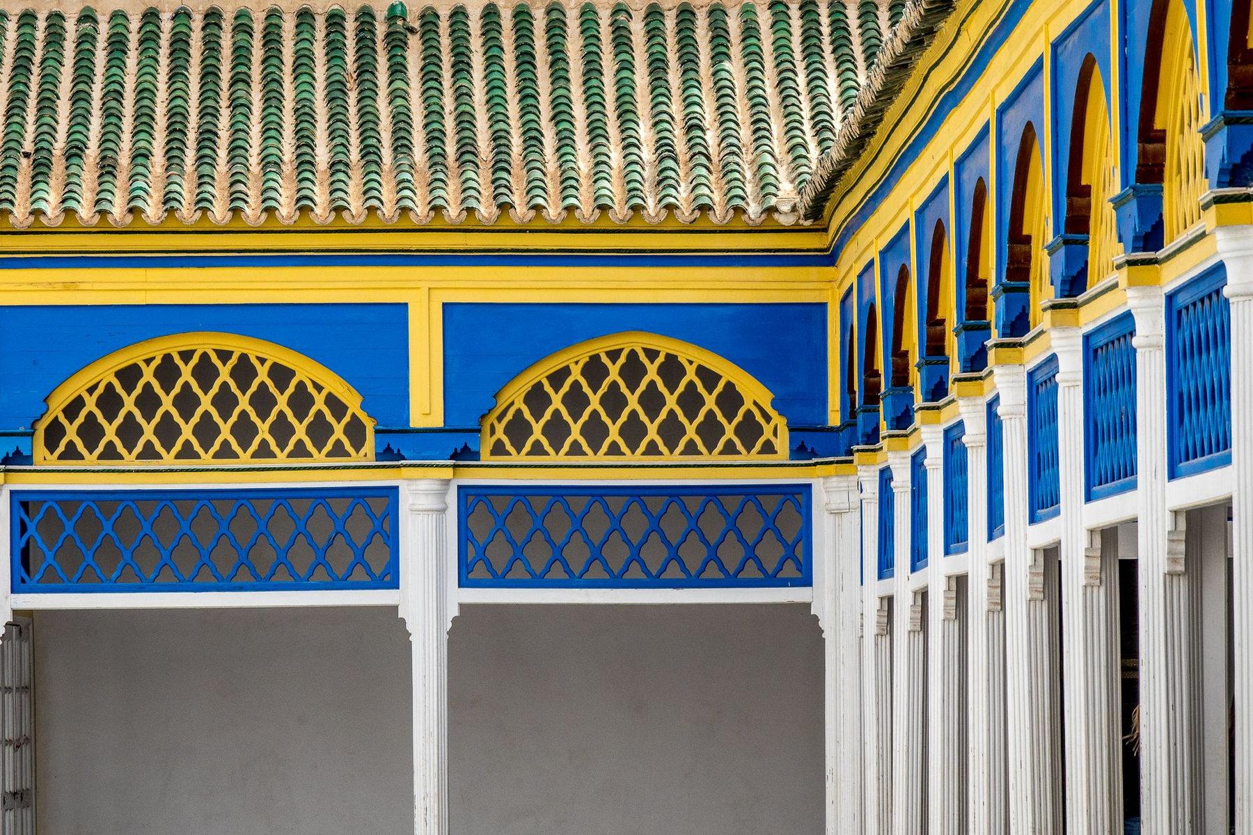 Blue and yellow arches in a Moroccan palace courtyard