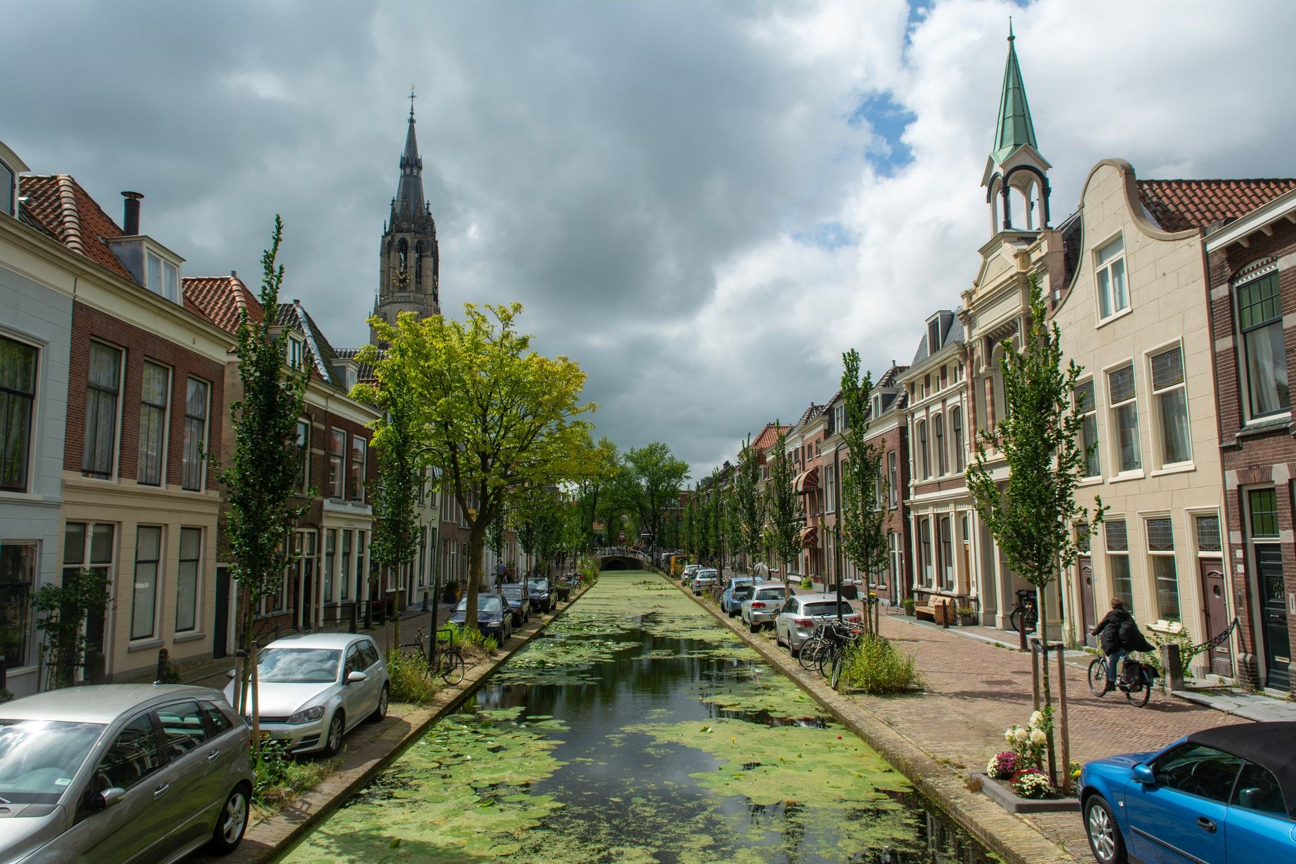 Historic tree-lined canals and brick arched bridges in Delft