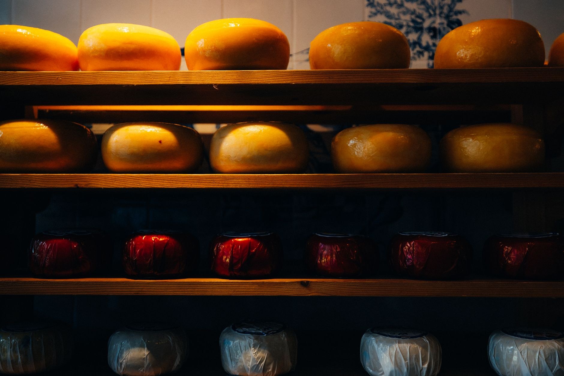 Fresh warm stroopwafels and wheels of artisan Gouda cheese at a Dutch market