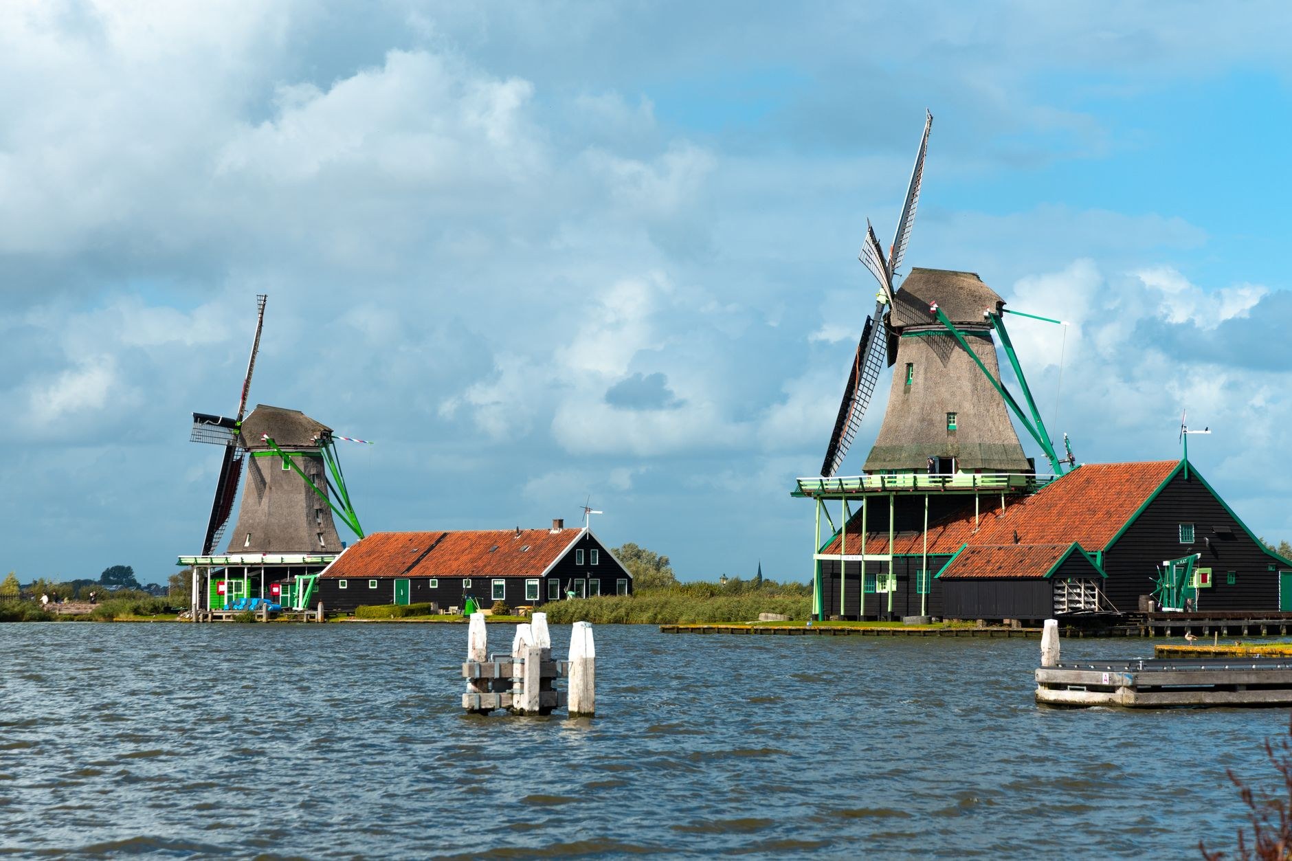 Historic preserved green wooden windmills along the river at Zaanse Schans